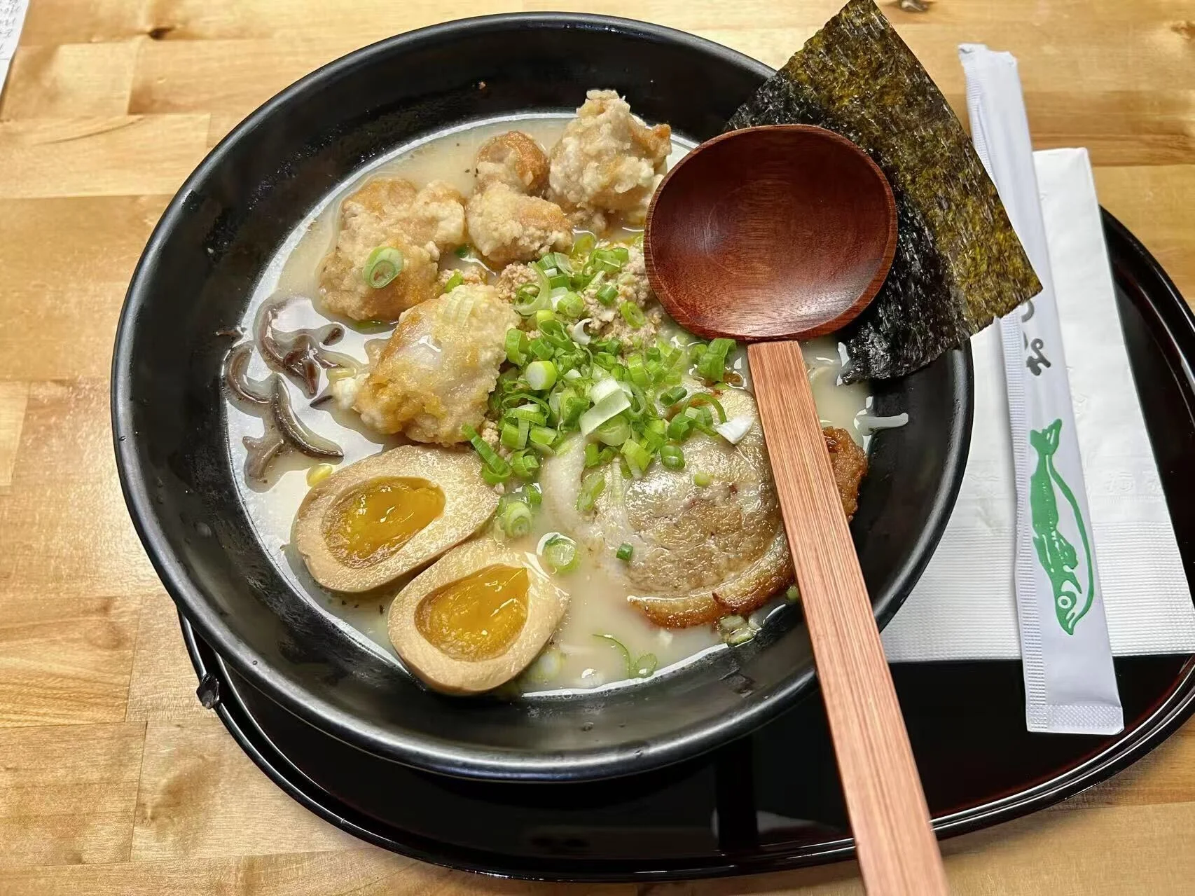 Japanese tonkotsu ramen topped with fried chicken and soft-boiled eggs