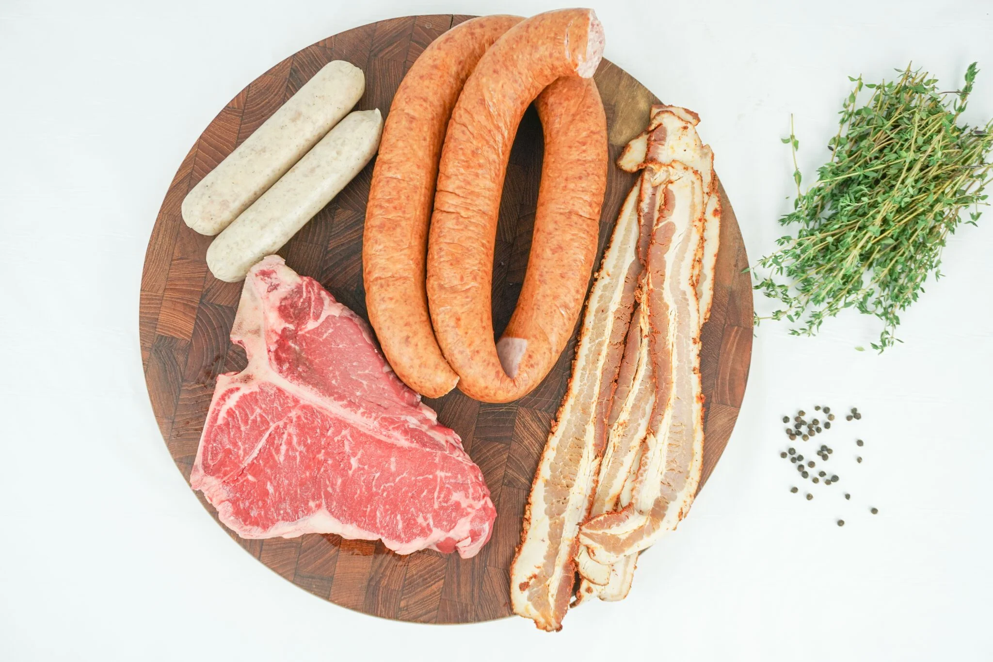 Assorted meats for grilling, including sausages and steak