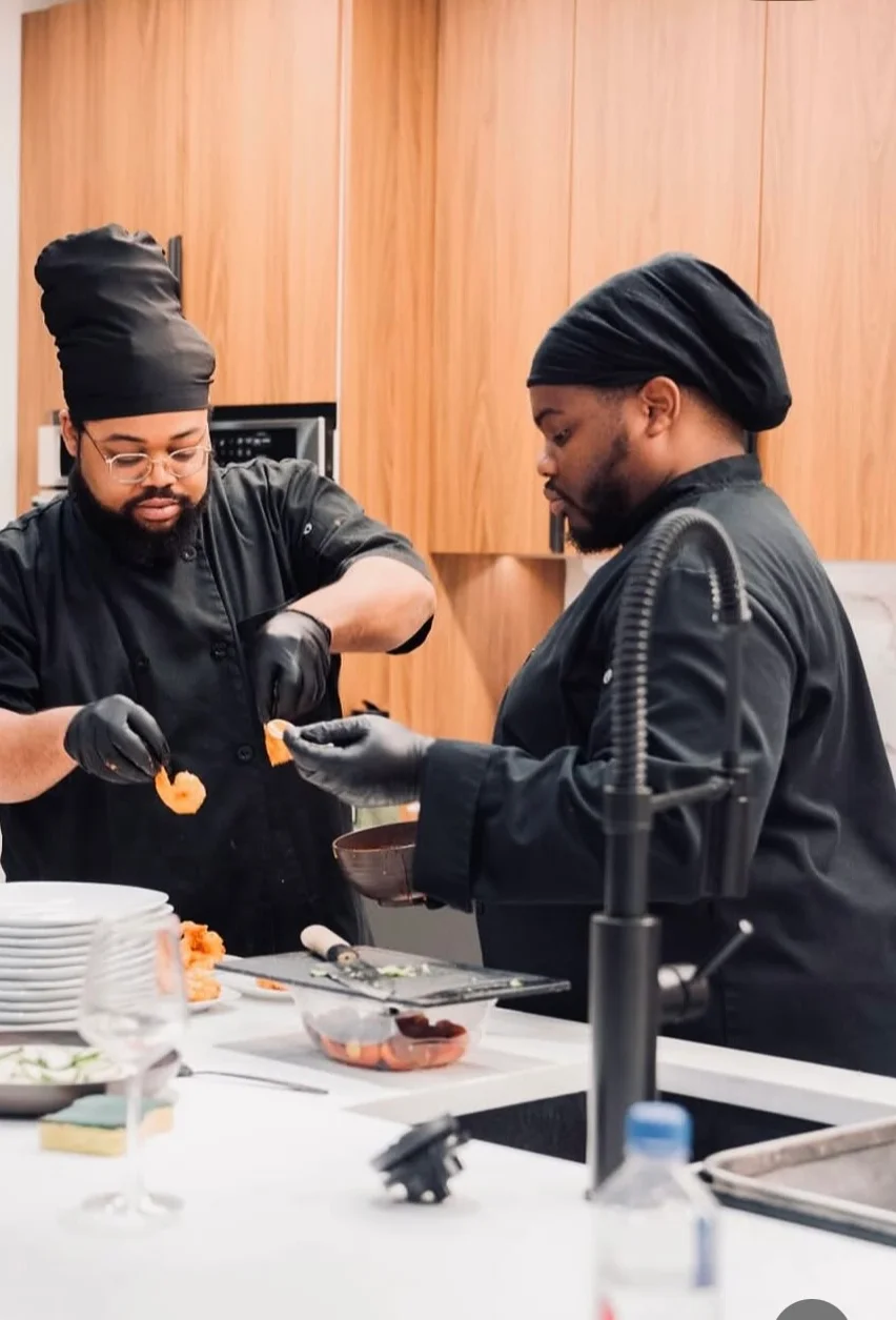 Chefs preparing shrimp in a modern kitchen