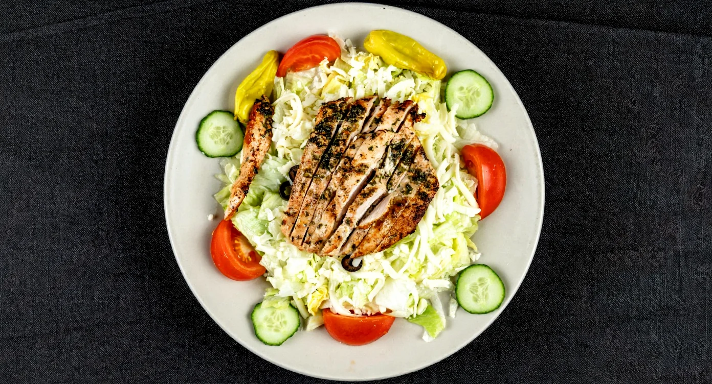 A delicious chicken salad from Hubbs Pizzeria, featuring fresh ingredients.