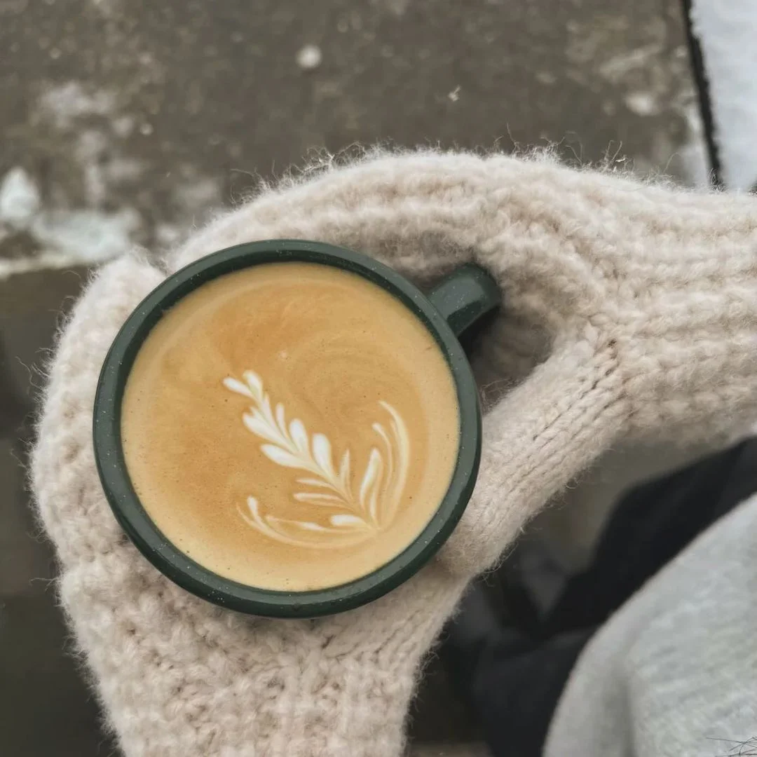 Artisan latte with beautiful leaf design in a cozy setting