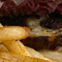 Delicious gourmet burger with fresh toppings on a wooden table