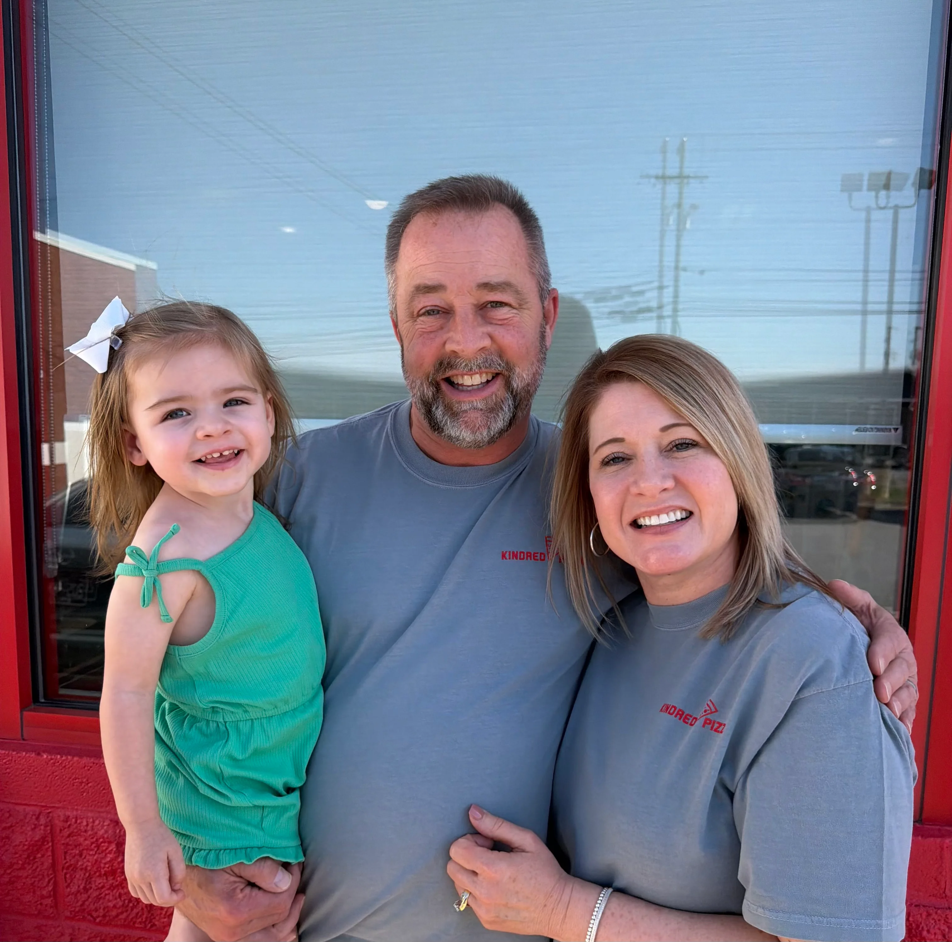 Family portrait outside a restaurant with smiles and warm atmosphere