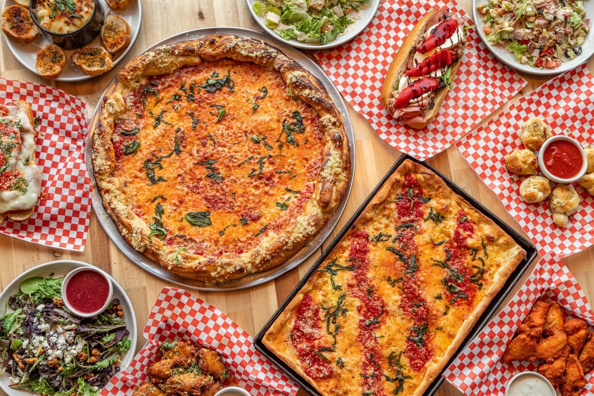 Variety of pizzas and sides in a casual dining setting