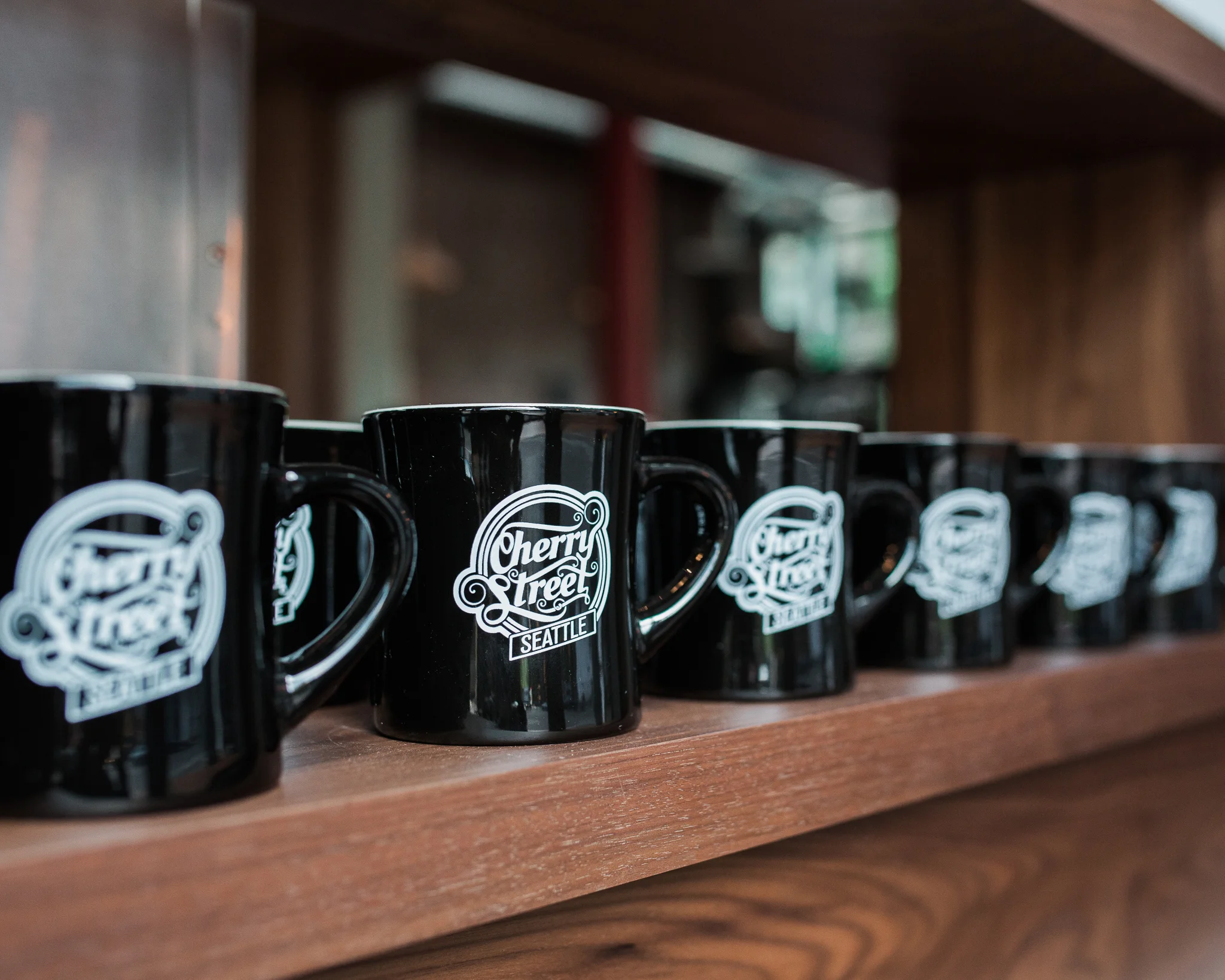 Collection of black coffee mugs from Cherry Street in Seattle