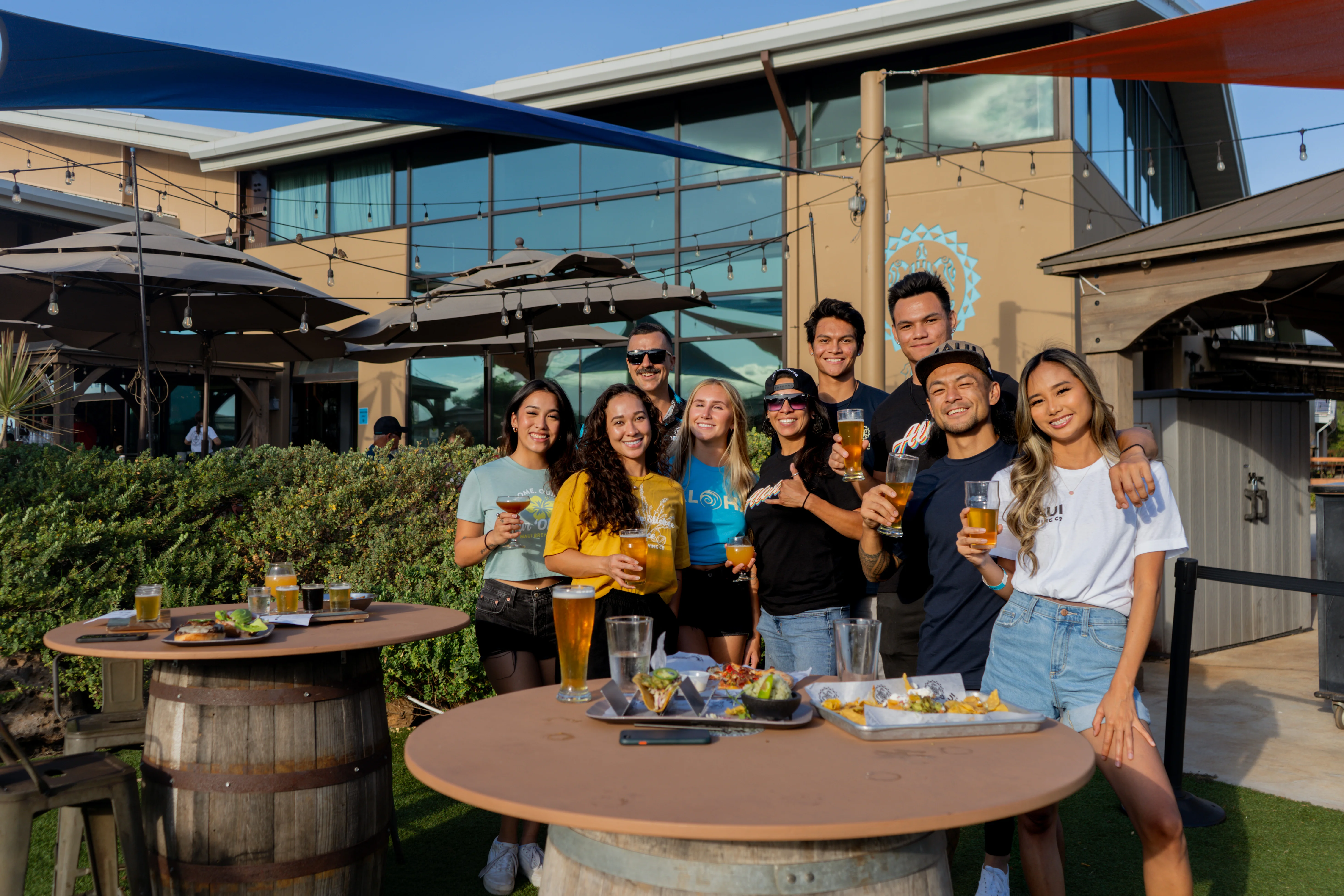 Group of friends enjoying drinks at a vibrant outdoor restaurant
