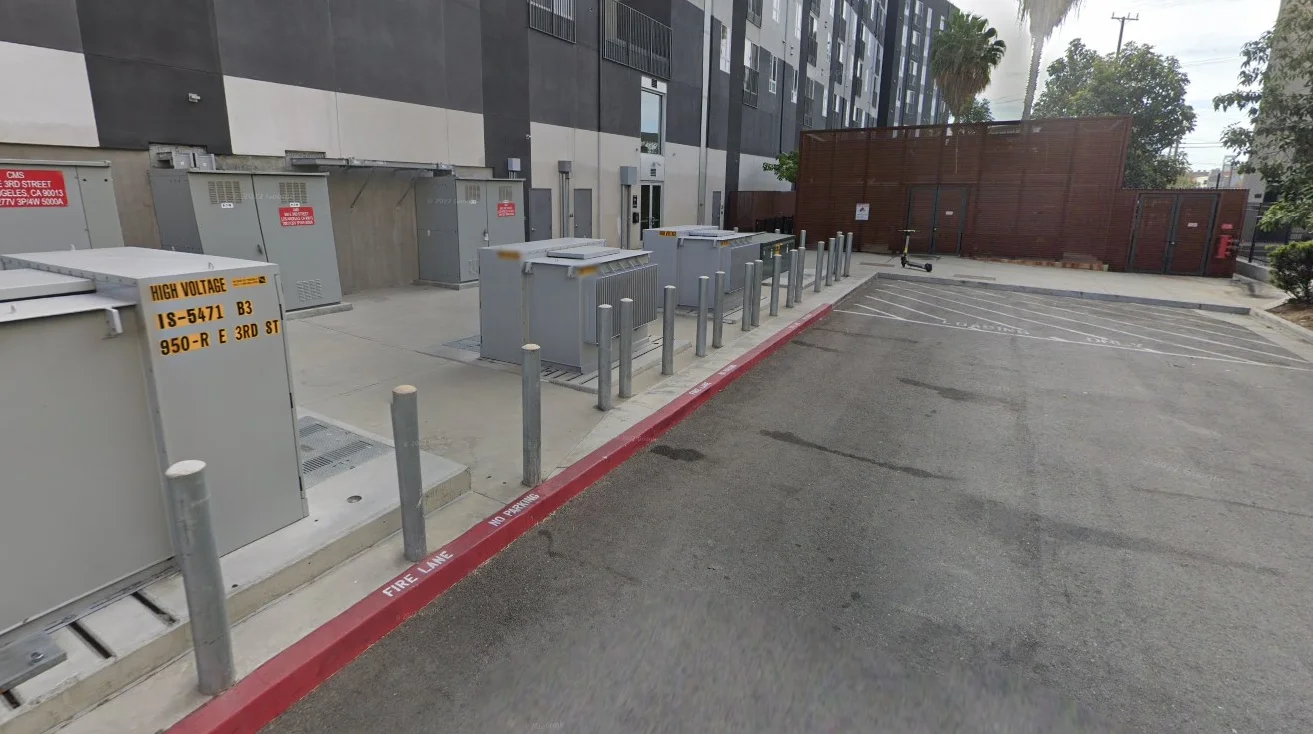 Utility area with electrical transformers and safety signage