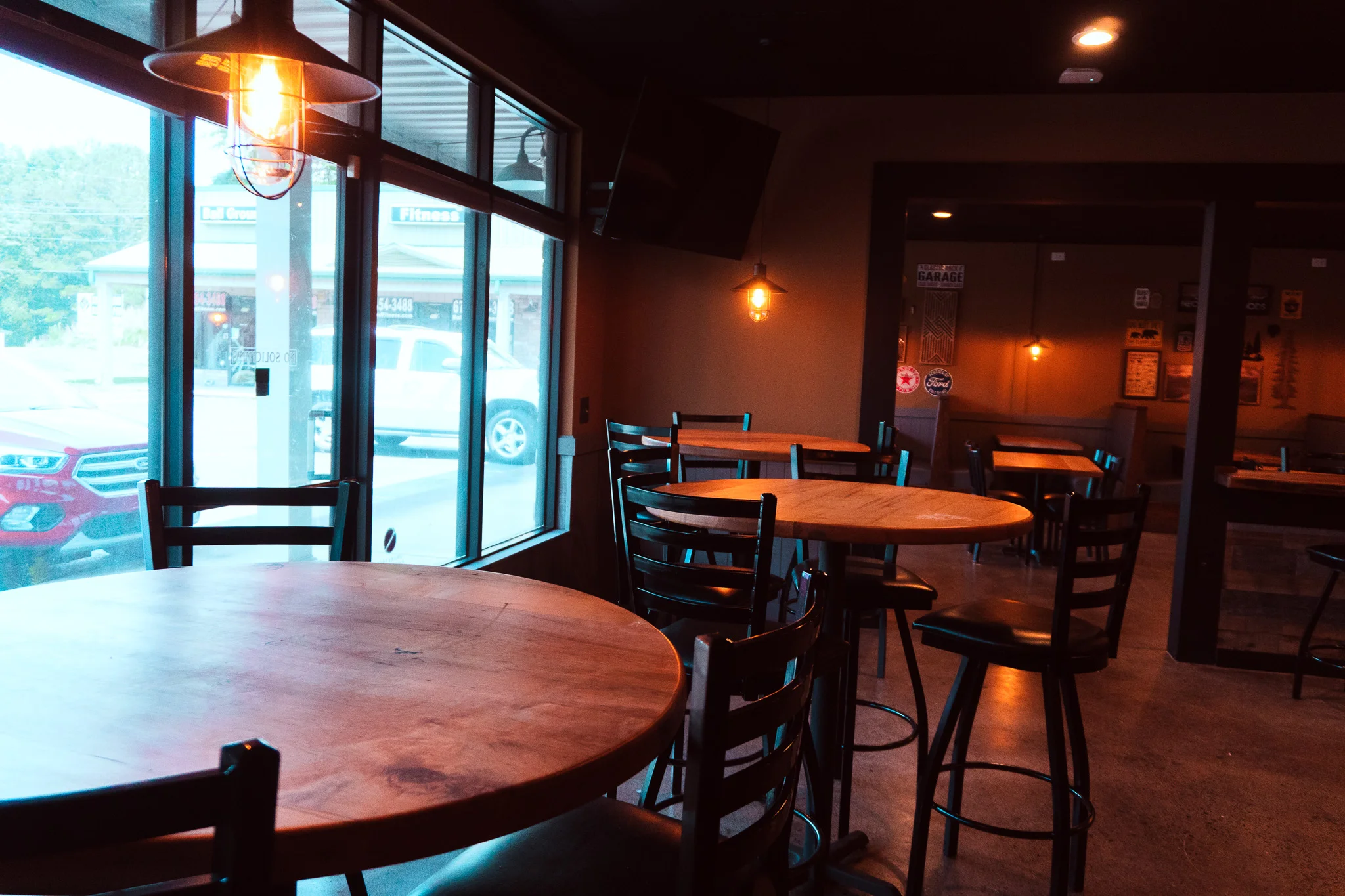 Cozy restaurant interior with wooden tables and warm lighting