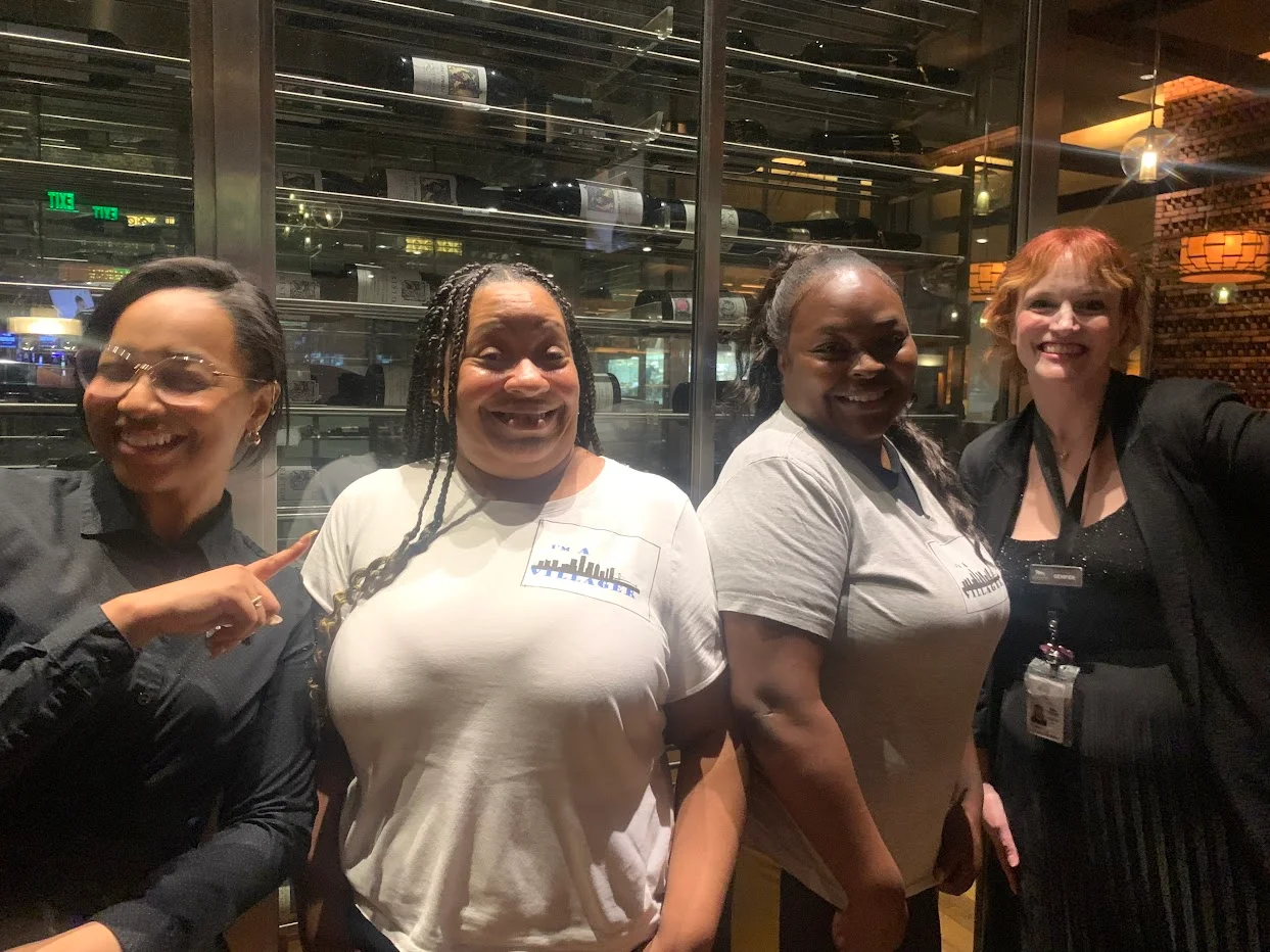 Friendly restaurant staff posing together in a modern dining space