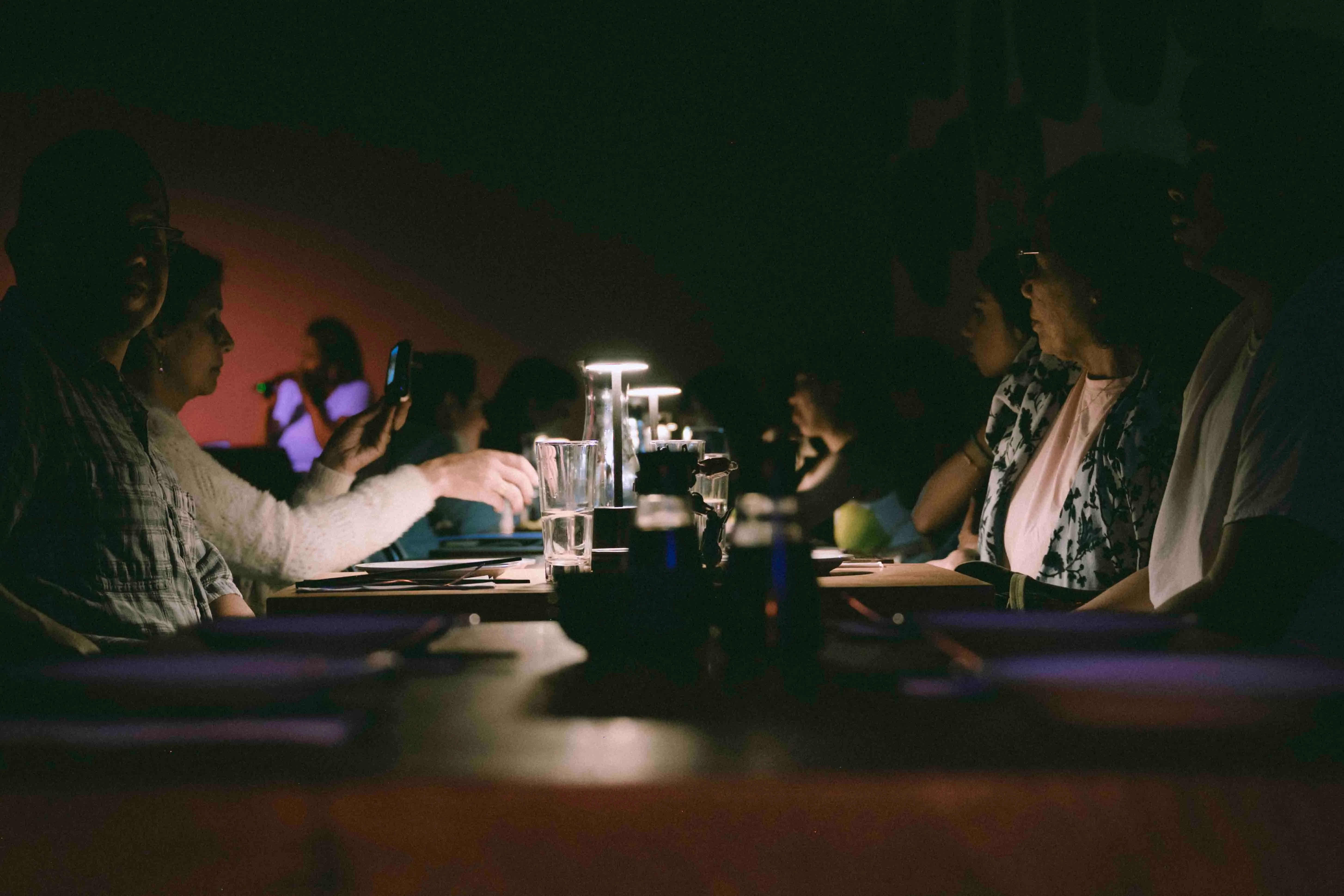 Cozy restaurant dining scene with guests enjoying a meal in low light