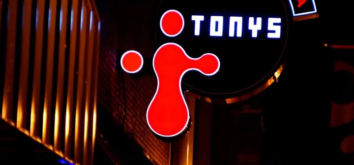 Illuminated restaurant sign for Tony's at night