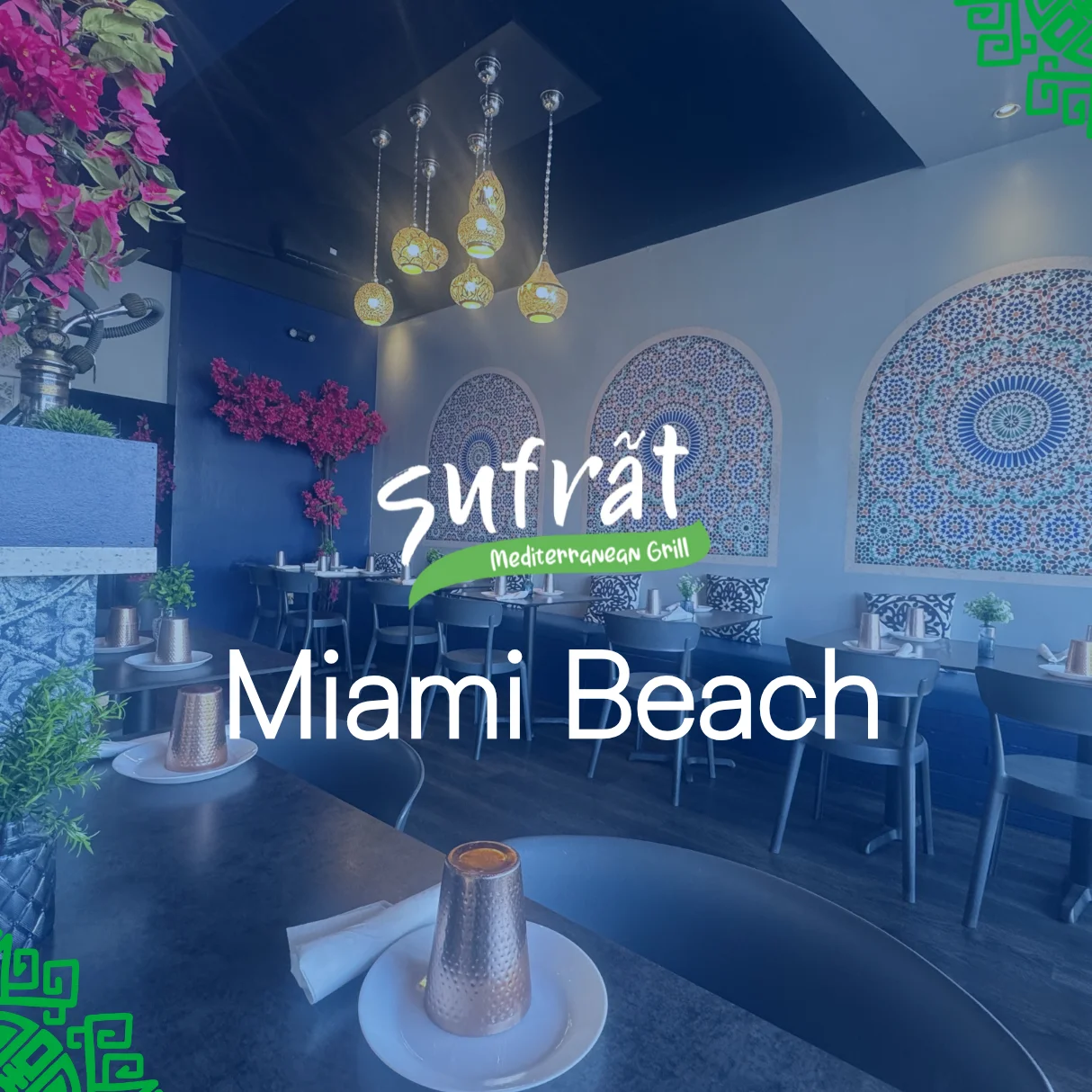 Modern Mediterranean cafe with wooden floors, green plants, and a decorative counter. Text overlays read "Sufrät Mediterranean Grill, Miami Beach." Cozy and inviting atmosphere.