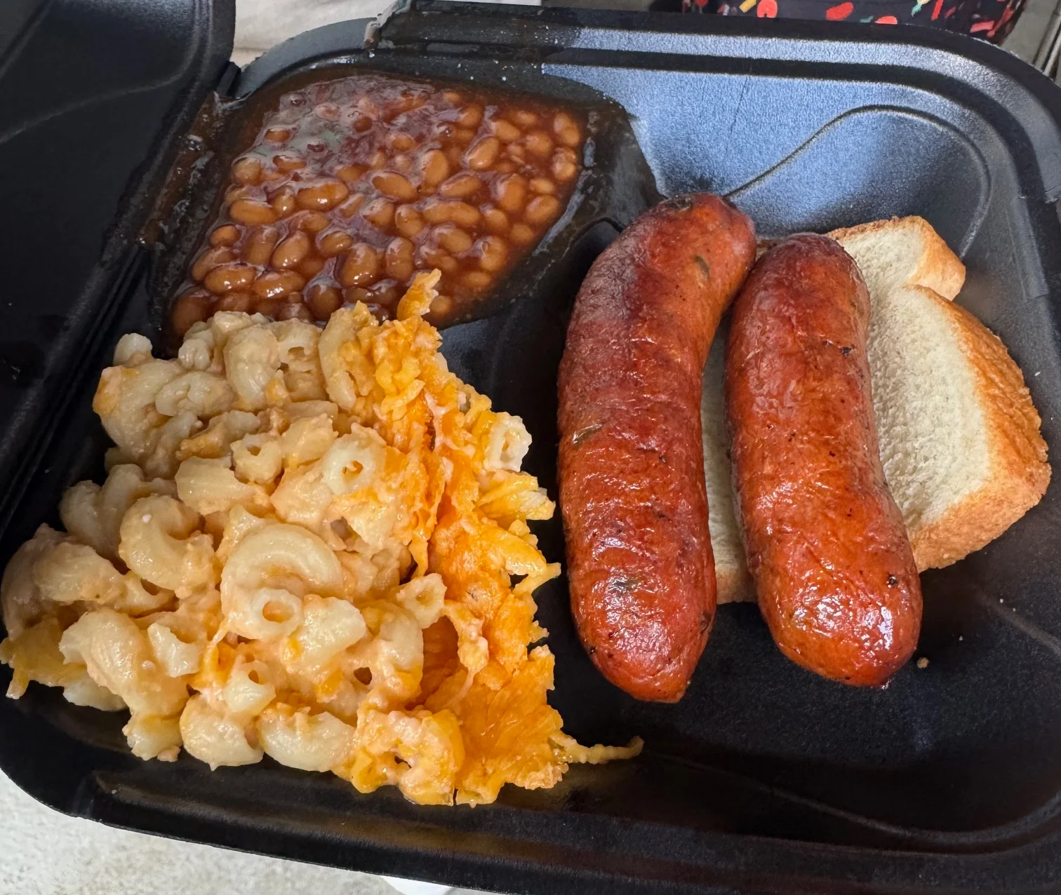 Southern-style barbecue platter with sausage and sides