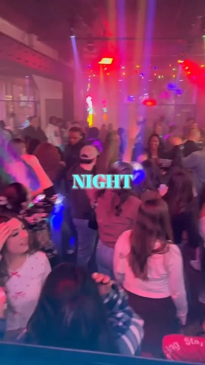 Vibrant nightlife scene with dancing crowd and colorful lights
