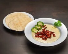 Bowl of Mexican queso fundido with tortillas