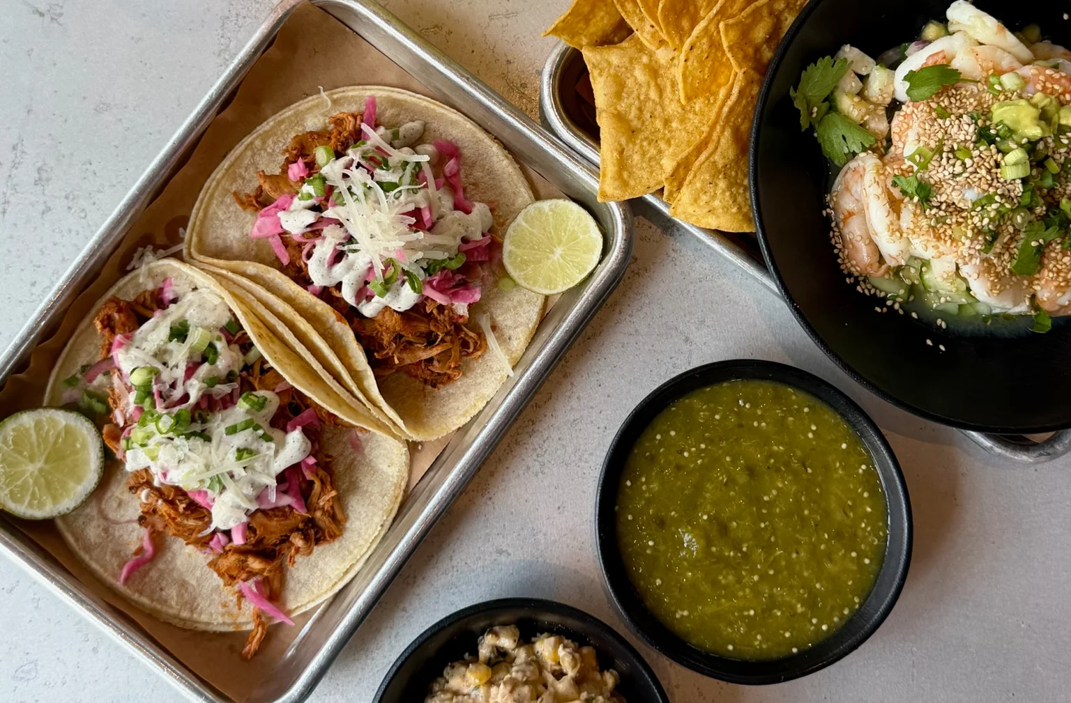 Delicious Mexican tacos with sides and refreshing cocktails