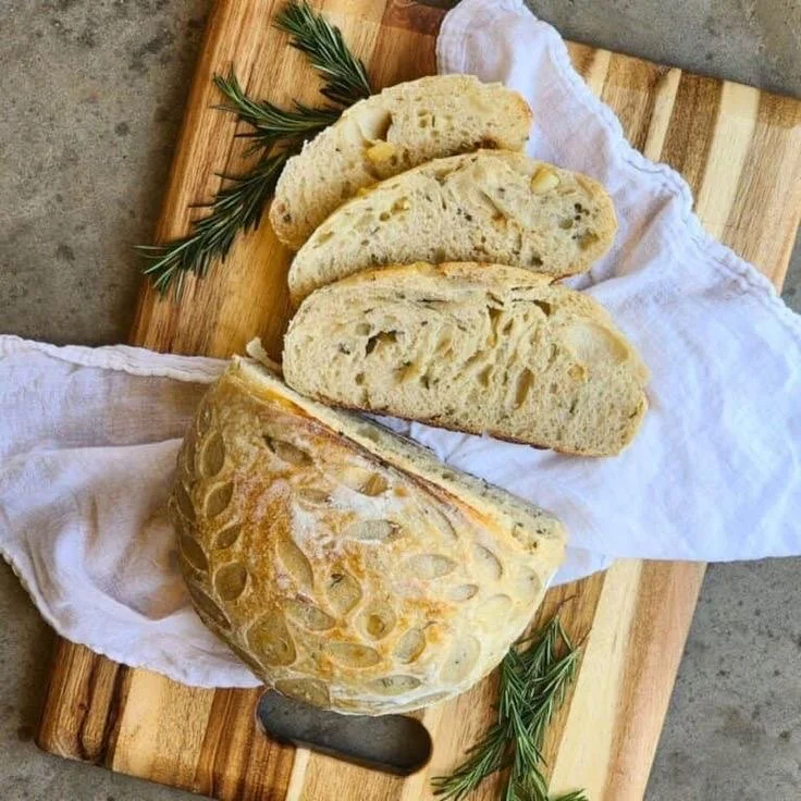 Artisan sourdough bread with rosemary on a wooden board