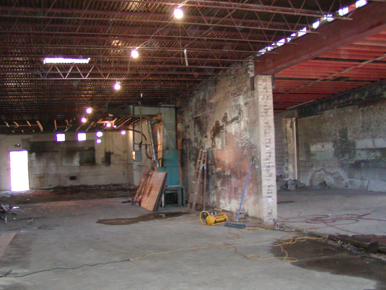 Empty restaurant interior with exposed brick and industrial lighting