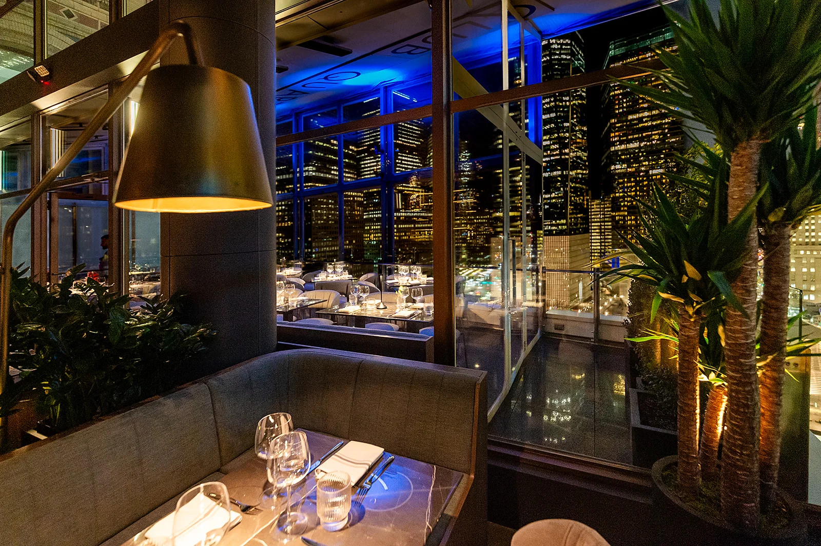 Elegant restaurant interior with city skyline view at night