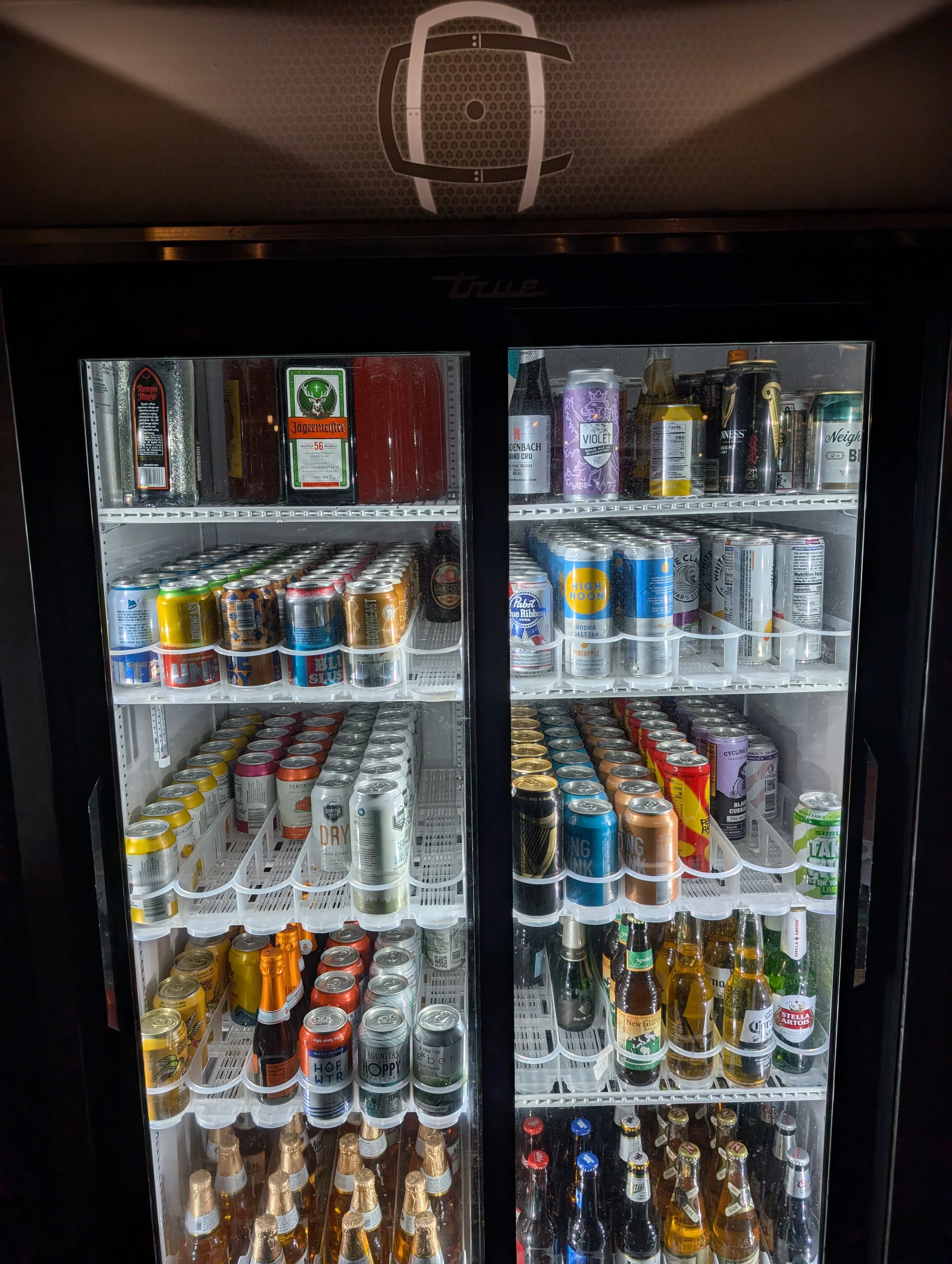 Refrigerator stocked with various beverages and craft beers