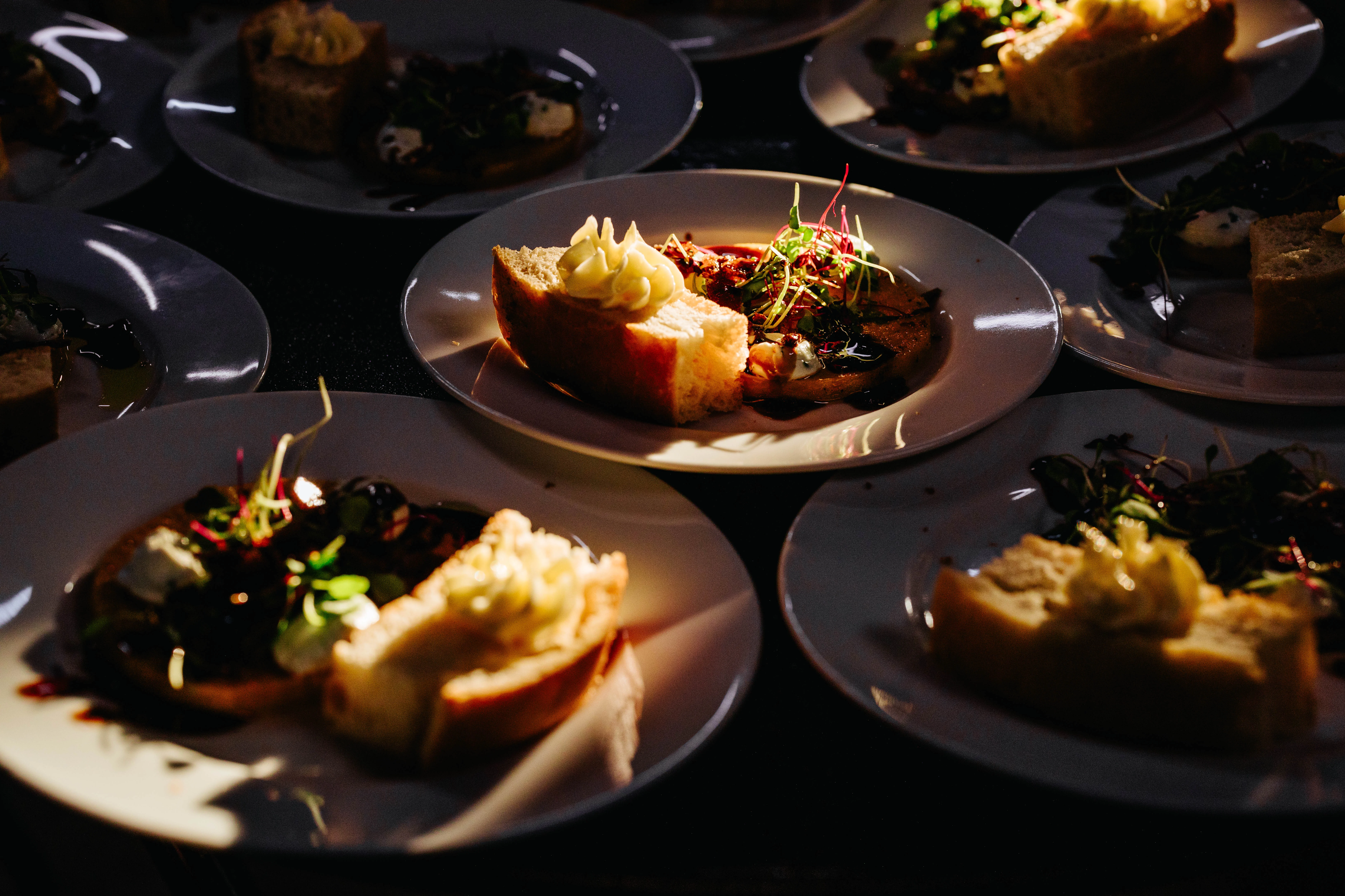 Artisan bread with gourmet toppings on elegant plates