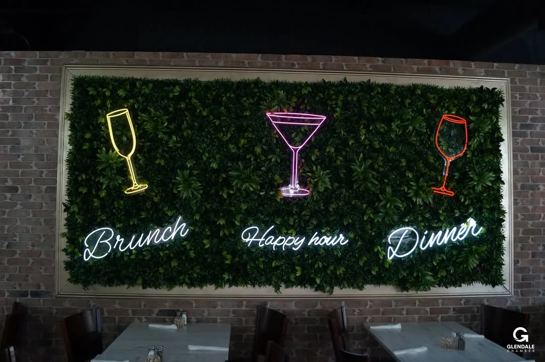 Cozy restaurant wall with neon signs for brunch, happy hour, and dinner