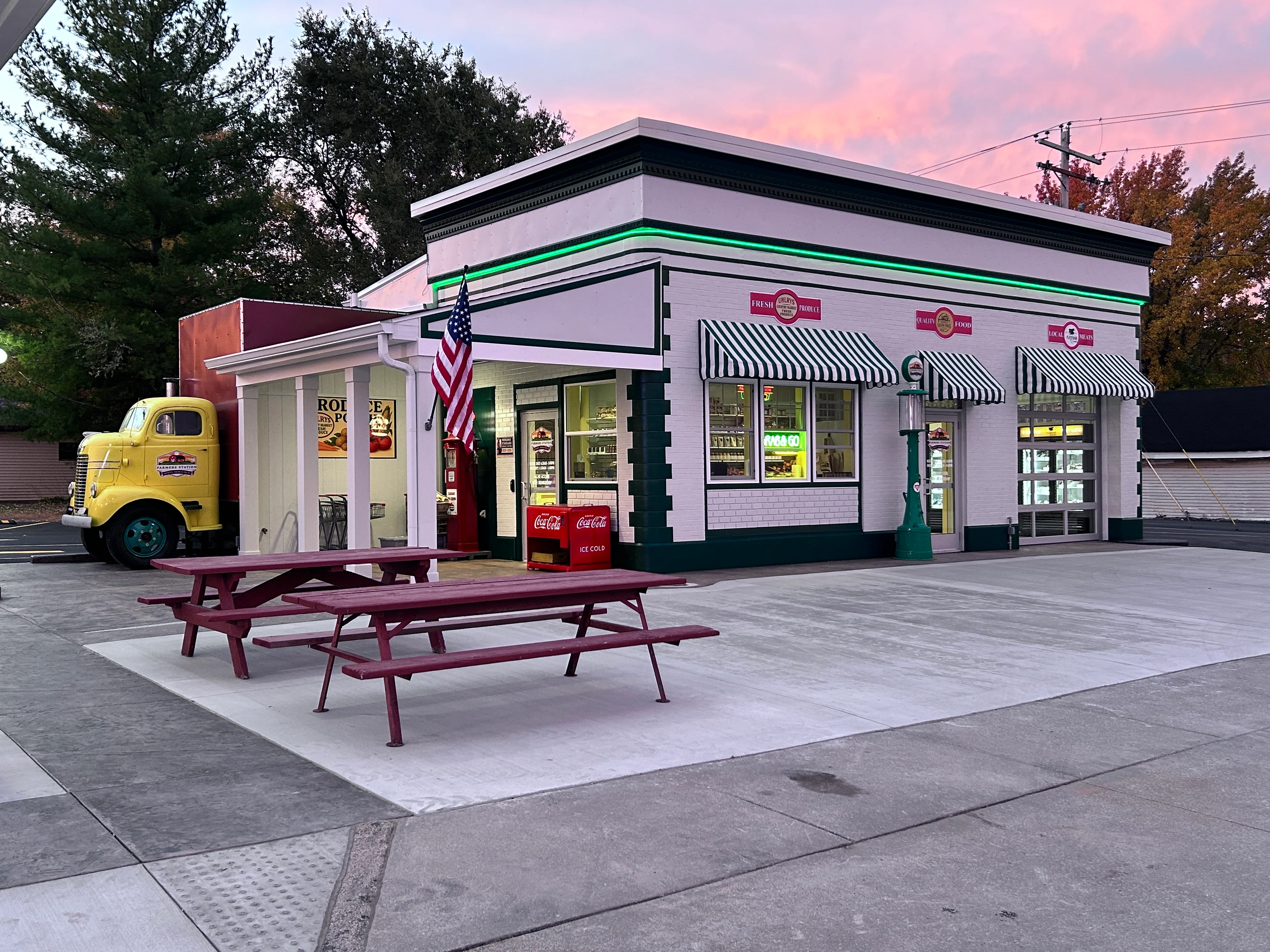 Charming retro diner exterior with vintage truck and picnic tables