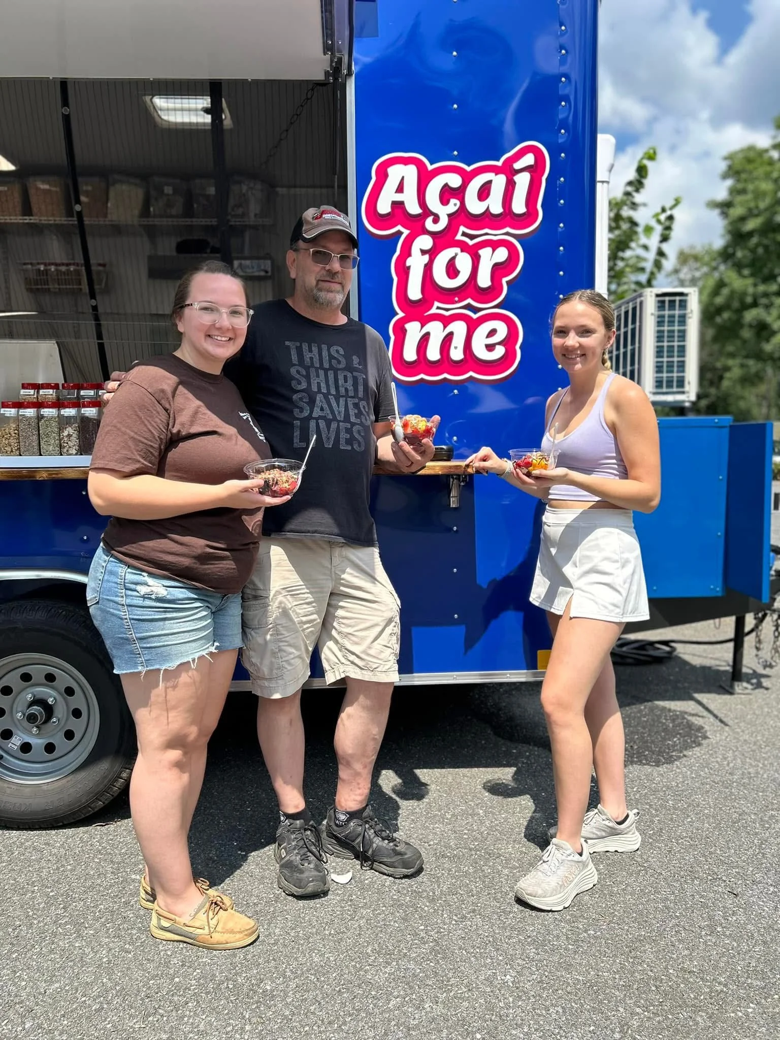 Customers enjoying açaí bowls from a food truck