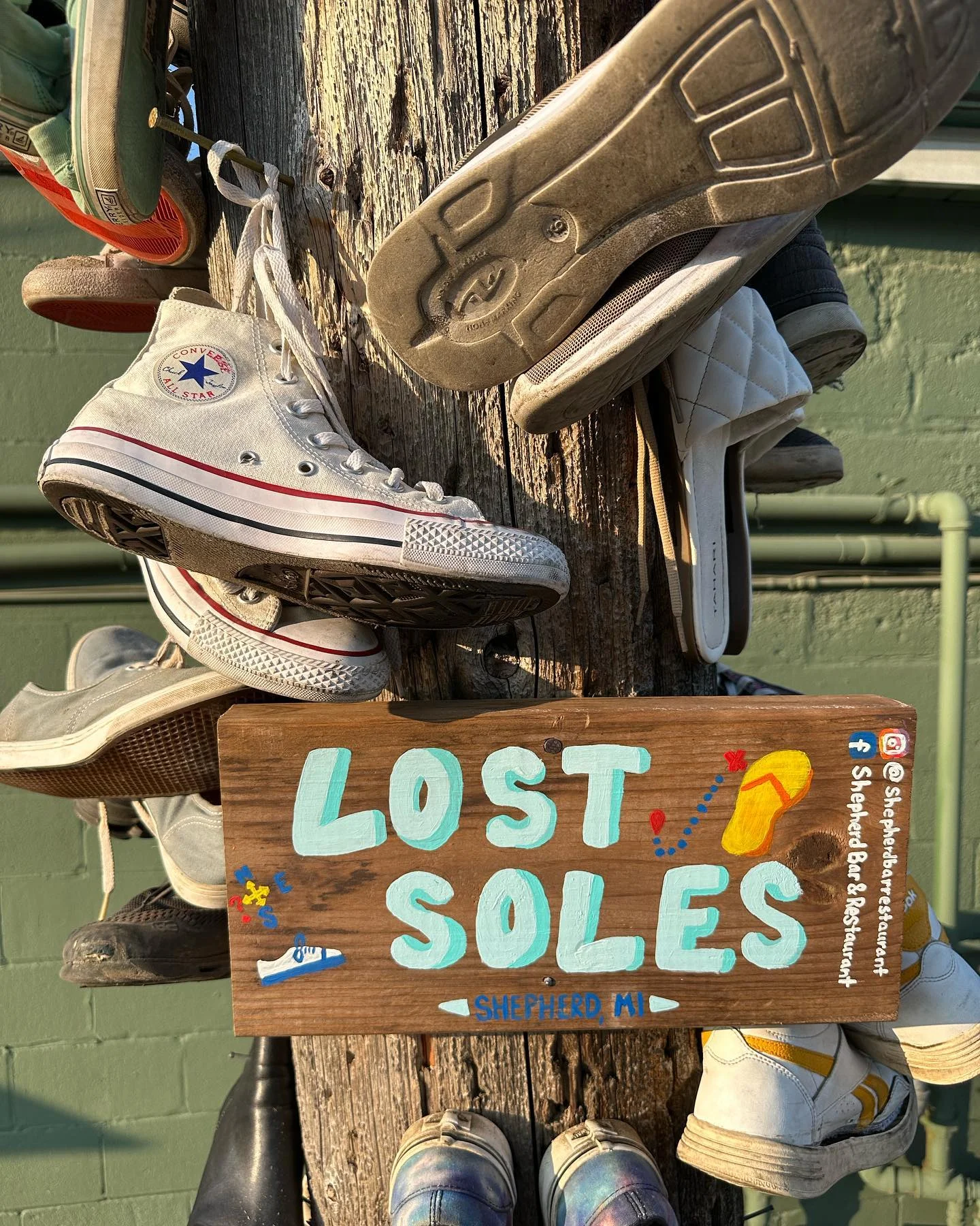 Unique shoe display with a sign reading 'Lost Soles' in Shepherd, MI