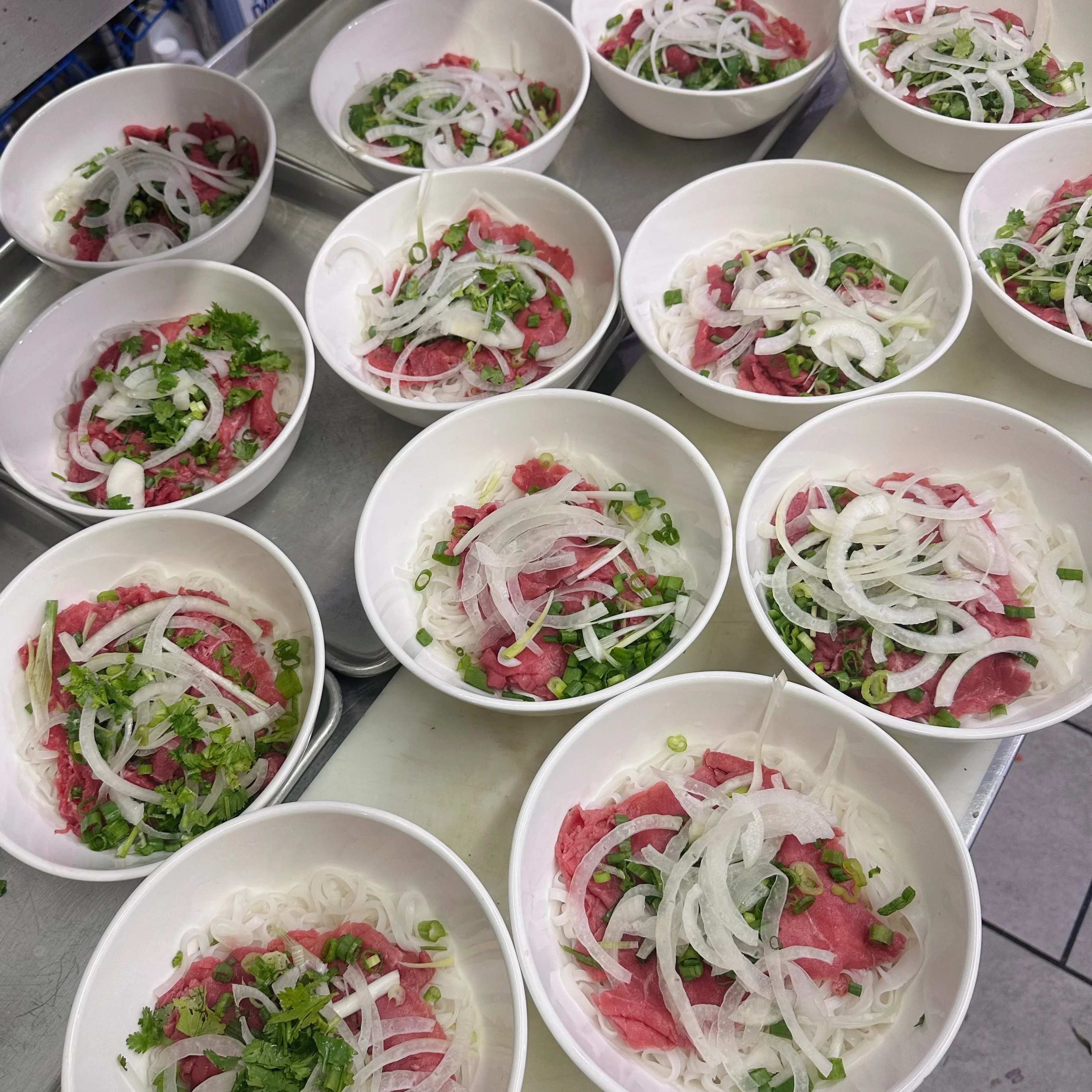 Vietnamese pho bowls with fresh herbs and beef
