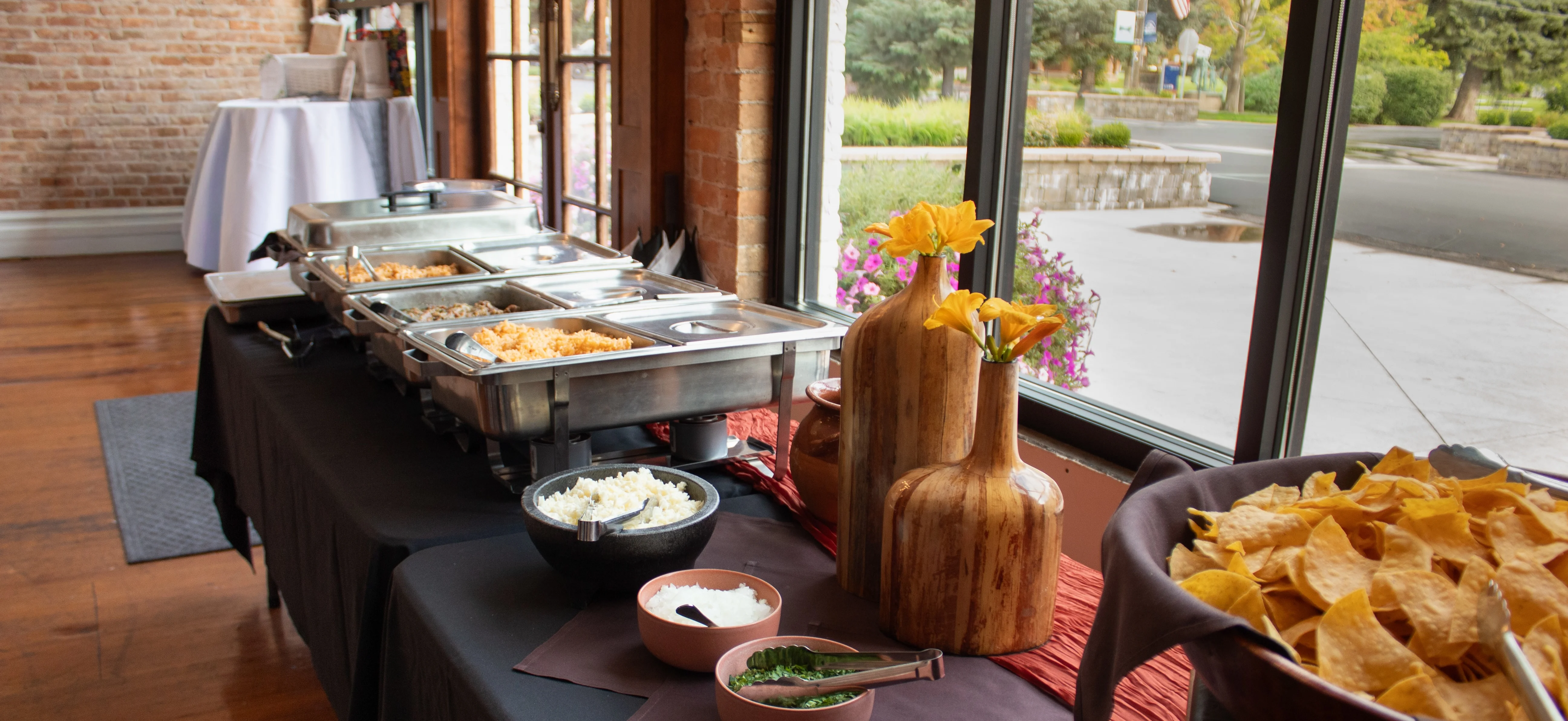 Buffet setup with Mexican dishes and vibrant decor