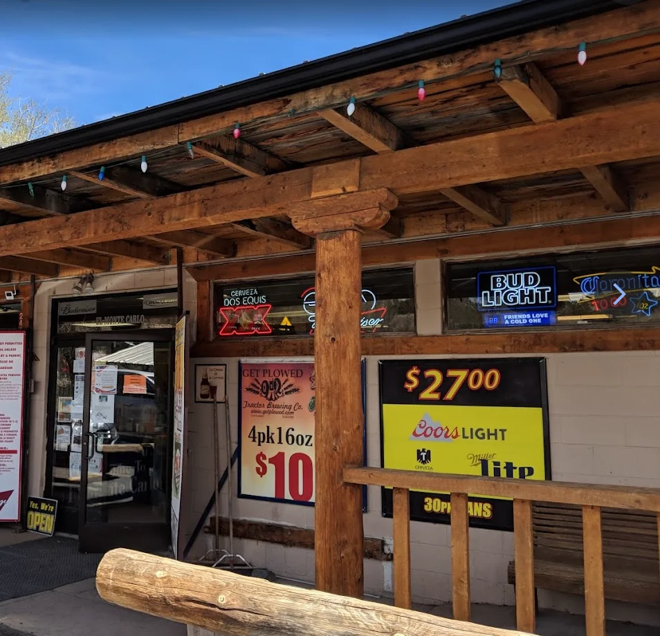 Rustic restaurant entrance with wooden beams and neon signs