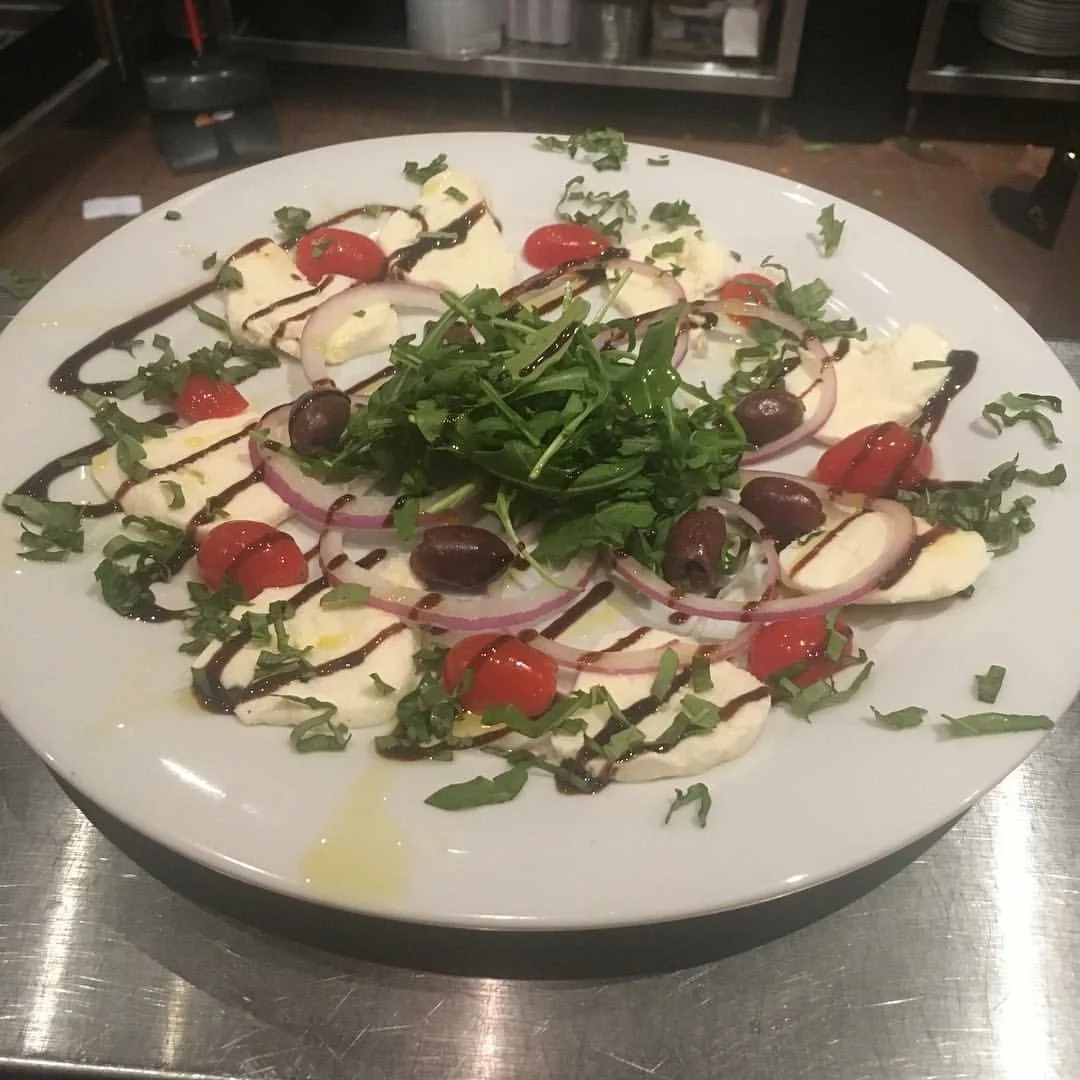 Mediterranean caprese salad with fresh herbs