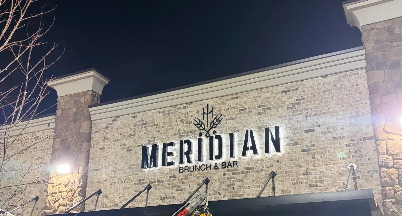 Meridian Brunch & Bar restaurant sign at night
