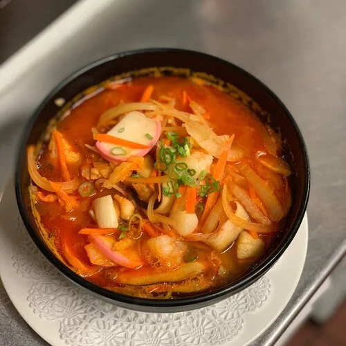 Spicy Korean jjigae with vegetables and seafood