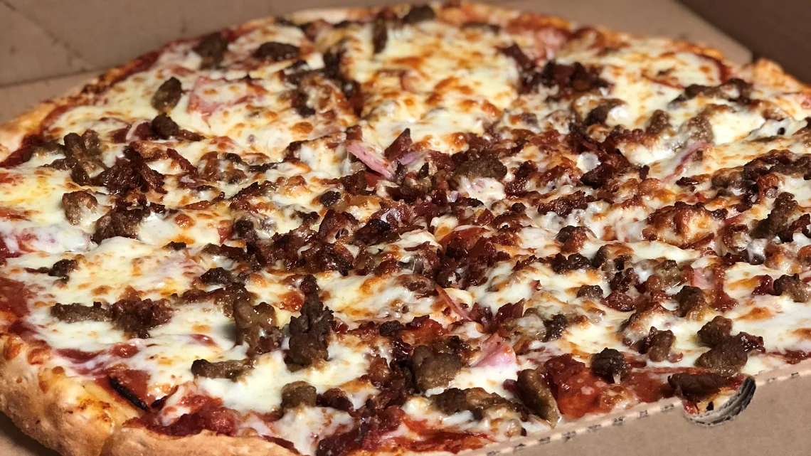Meat lover's pizza with cheese and savory toppings