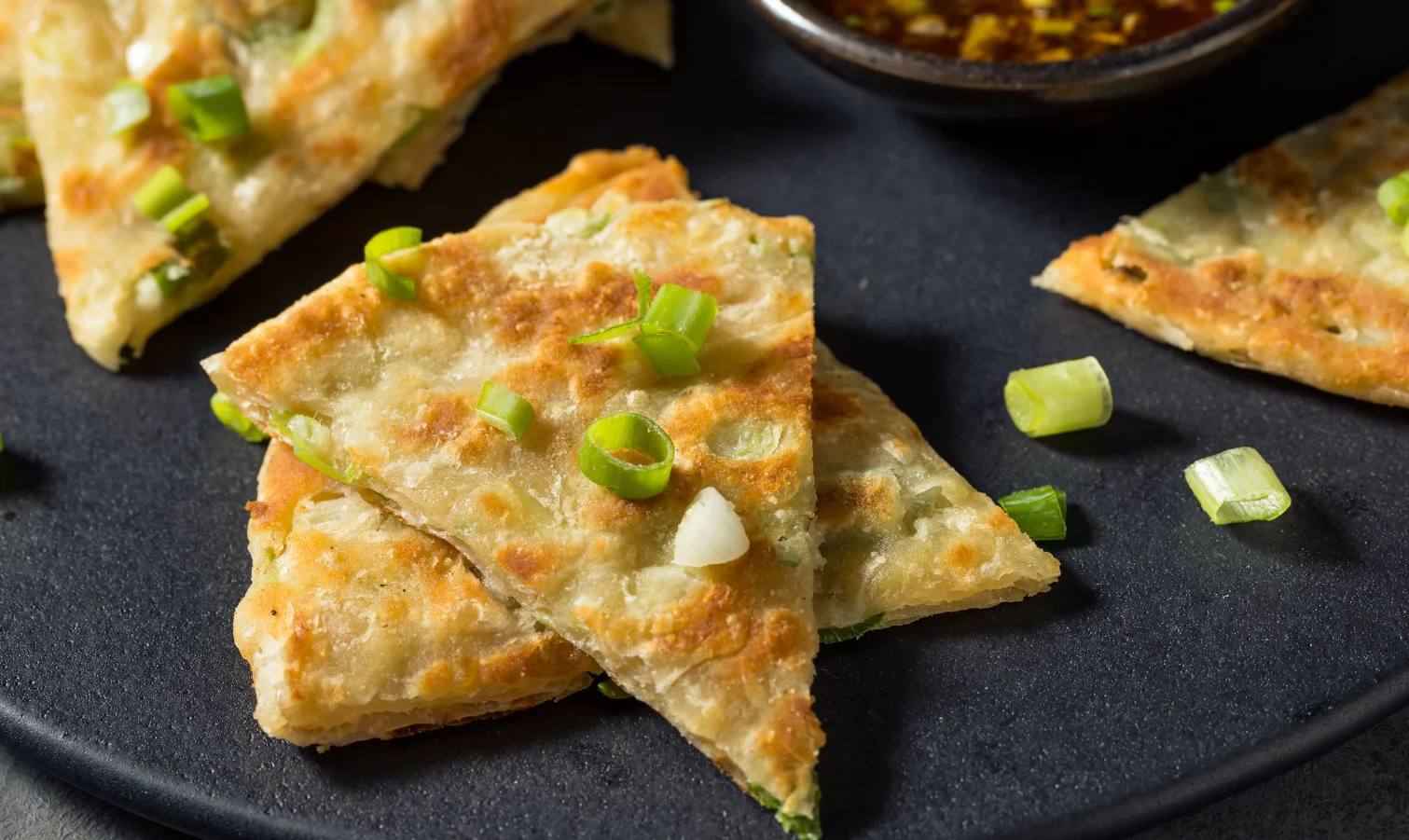 Crispy Chinese scallion pancakes served with dipping sauce