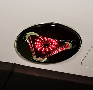 Red LED light in a triangular shape on a black background.