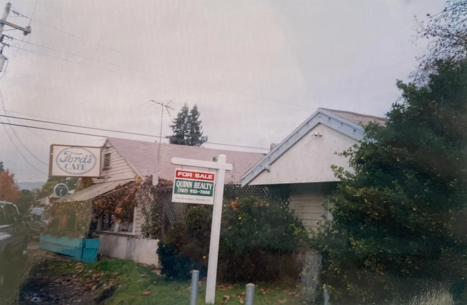 Exterior view of Ford's Cafe with a for sale sign
