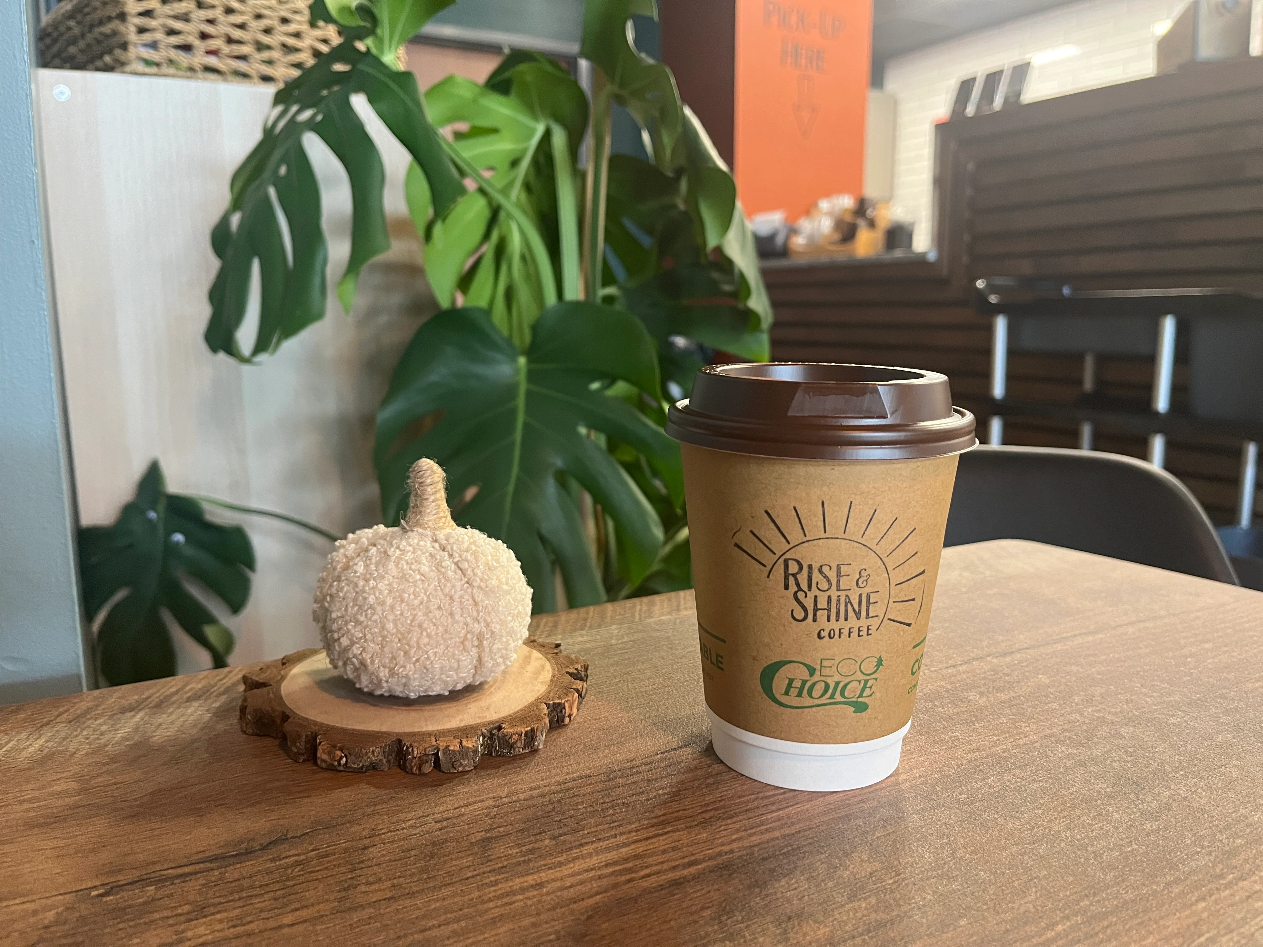 Coffee cup on a wooden table in a cozy café setting