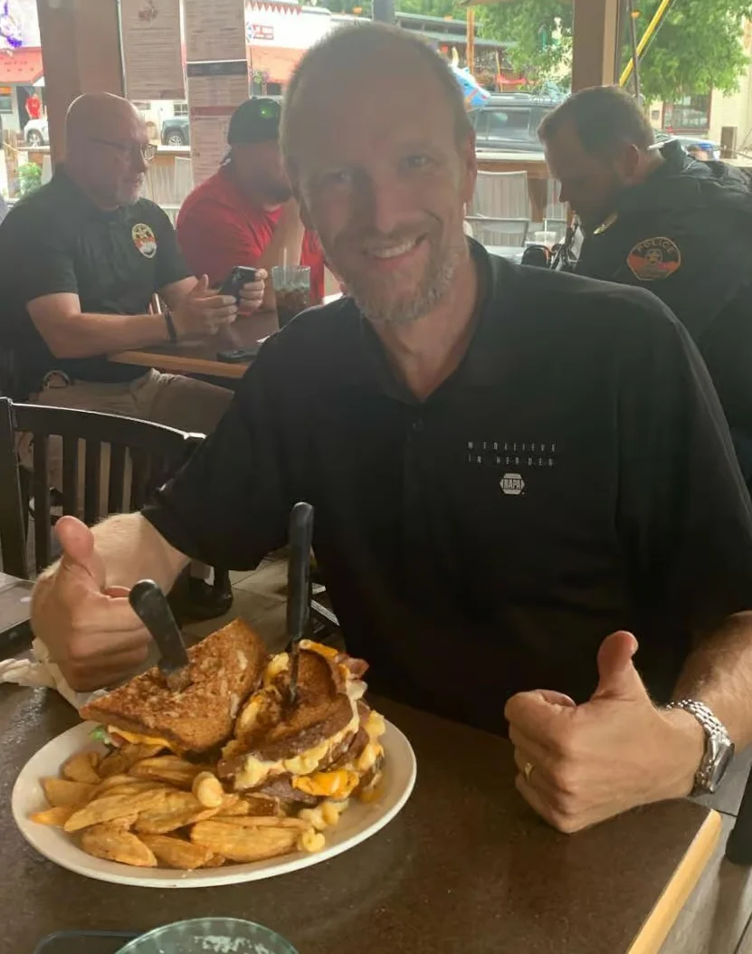 Giant American cheeseburger with fries in a casual dining setting