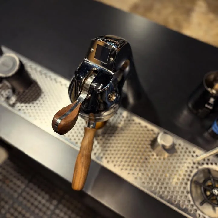 Espresso machine with wooden lever at a coffee bar