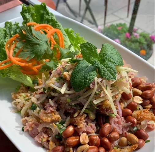 Nam Khao Todd, a delectable Laos Thai dish of Crispy Curry Rice, Peanut, Herbs, Pork Sausage