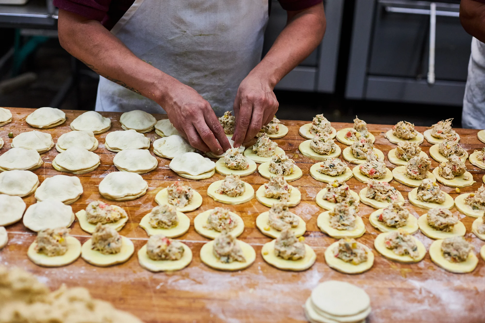 Preparing crab dumplings in a bustling kitchen