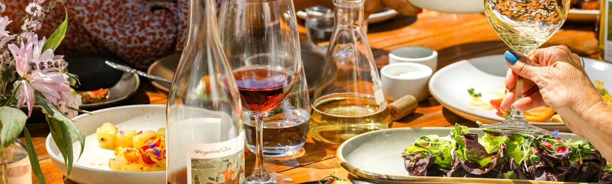 Elegant dining table with assorted dishes and wine