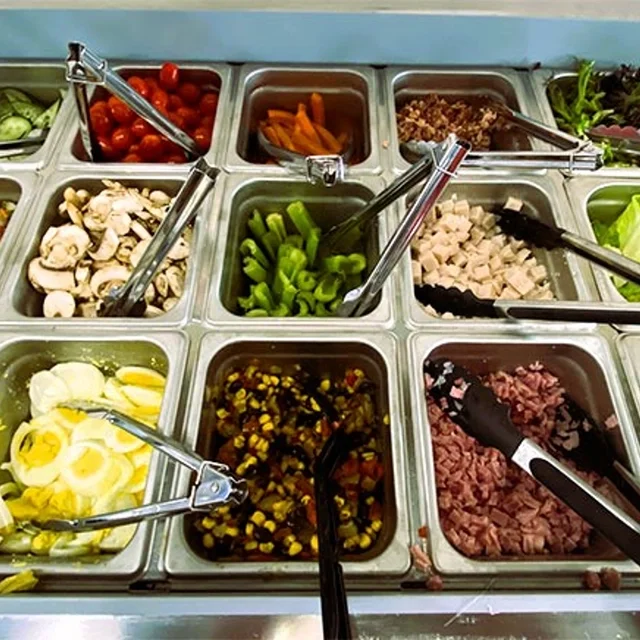 Fresh salad bar with a variety of toppings and ingredients