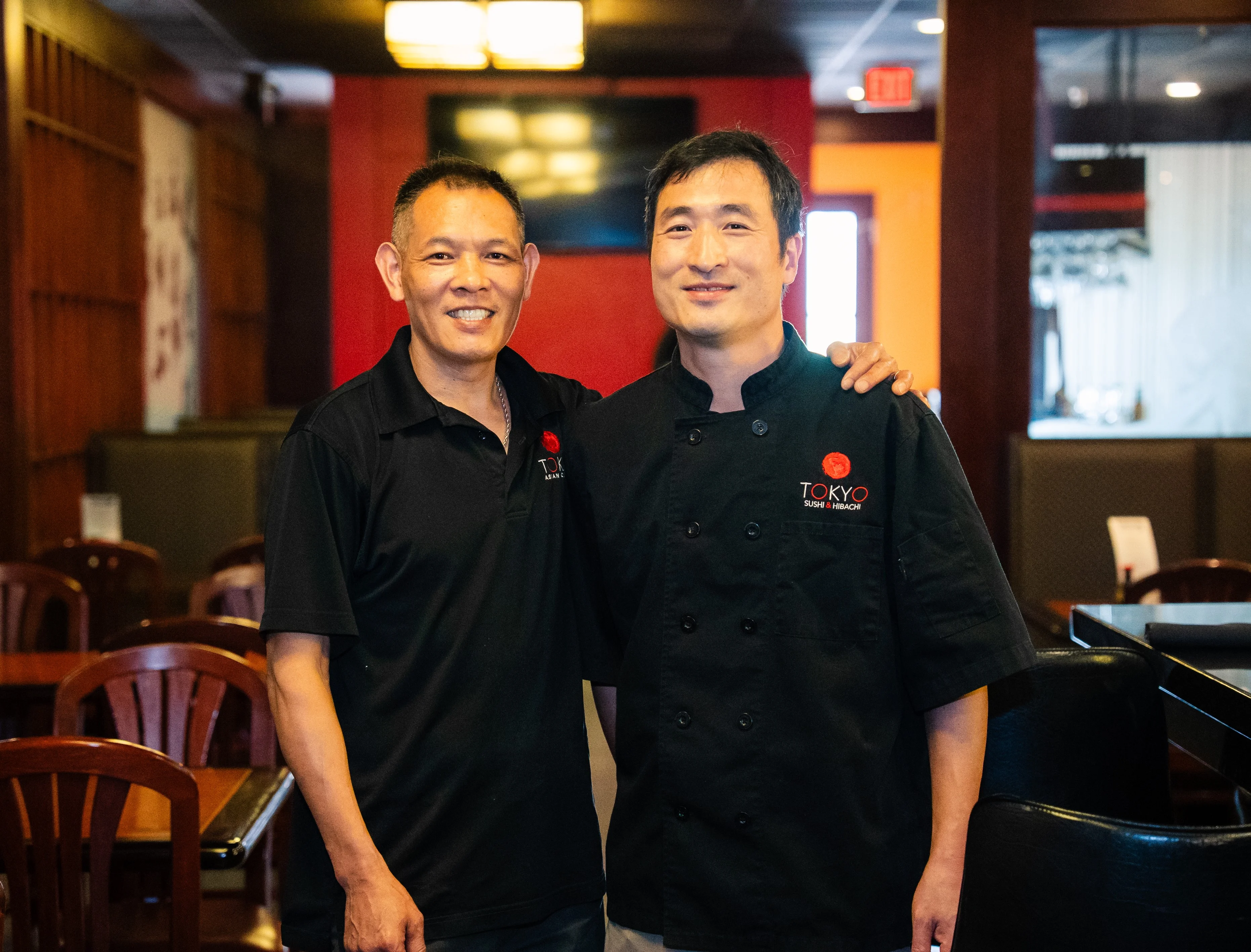 Chefs posing in a Japanese sushi restaurant interior