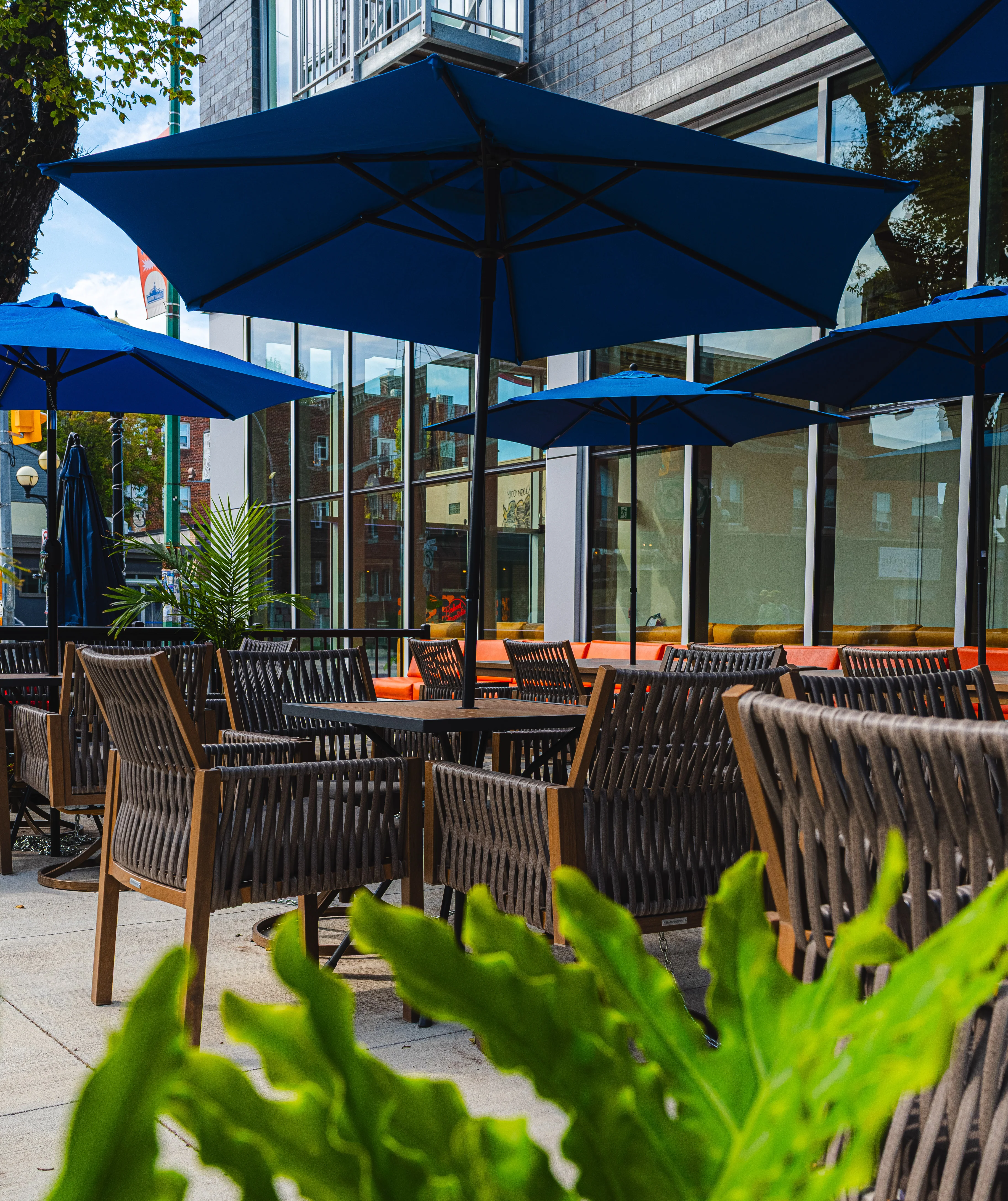 Outdoor dining area with blue umbrellas and wooden furniture