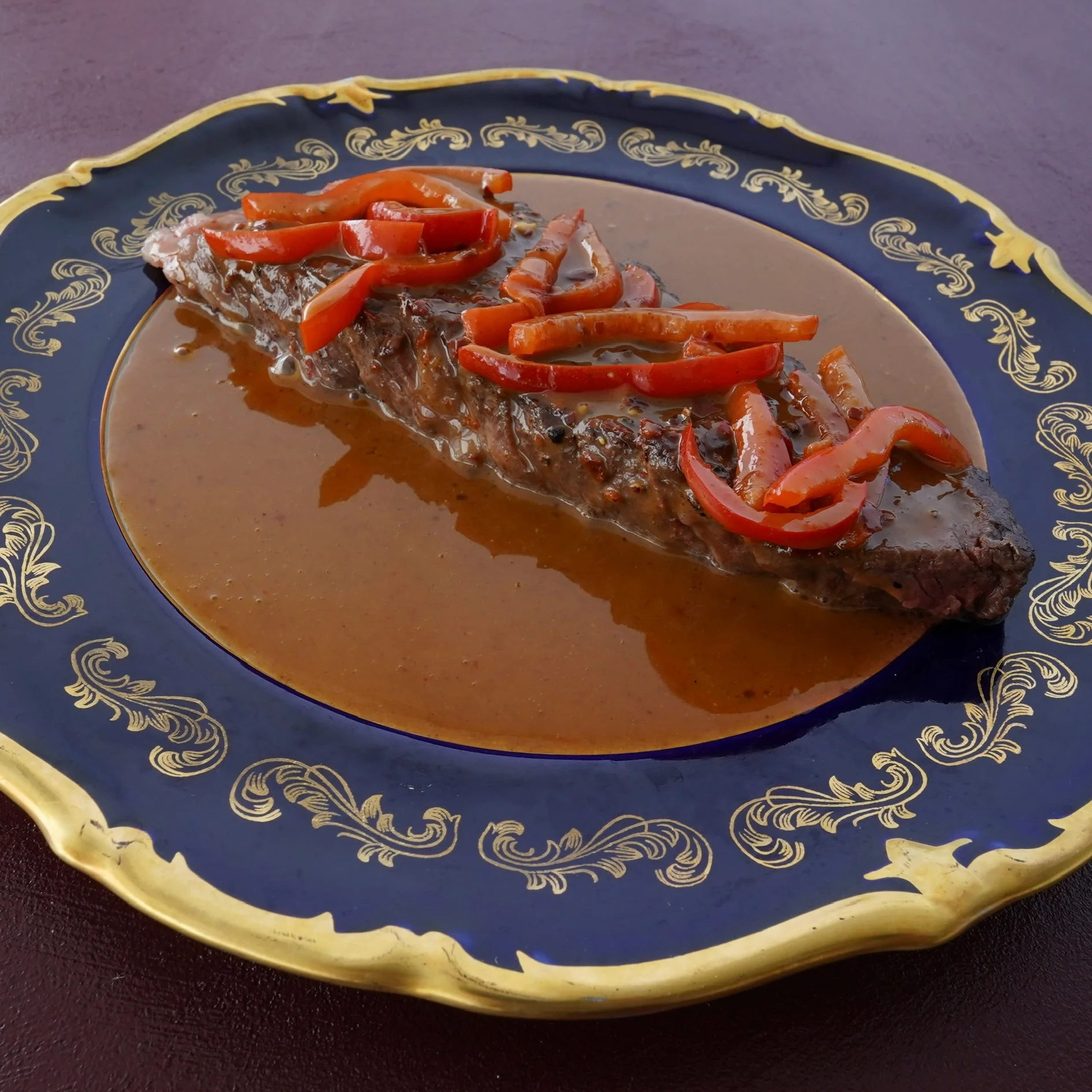 Tender Brazilian picanha with red peppers in savory sauce