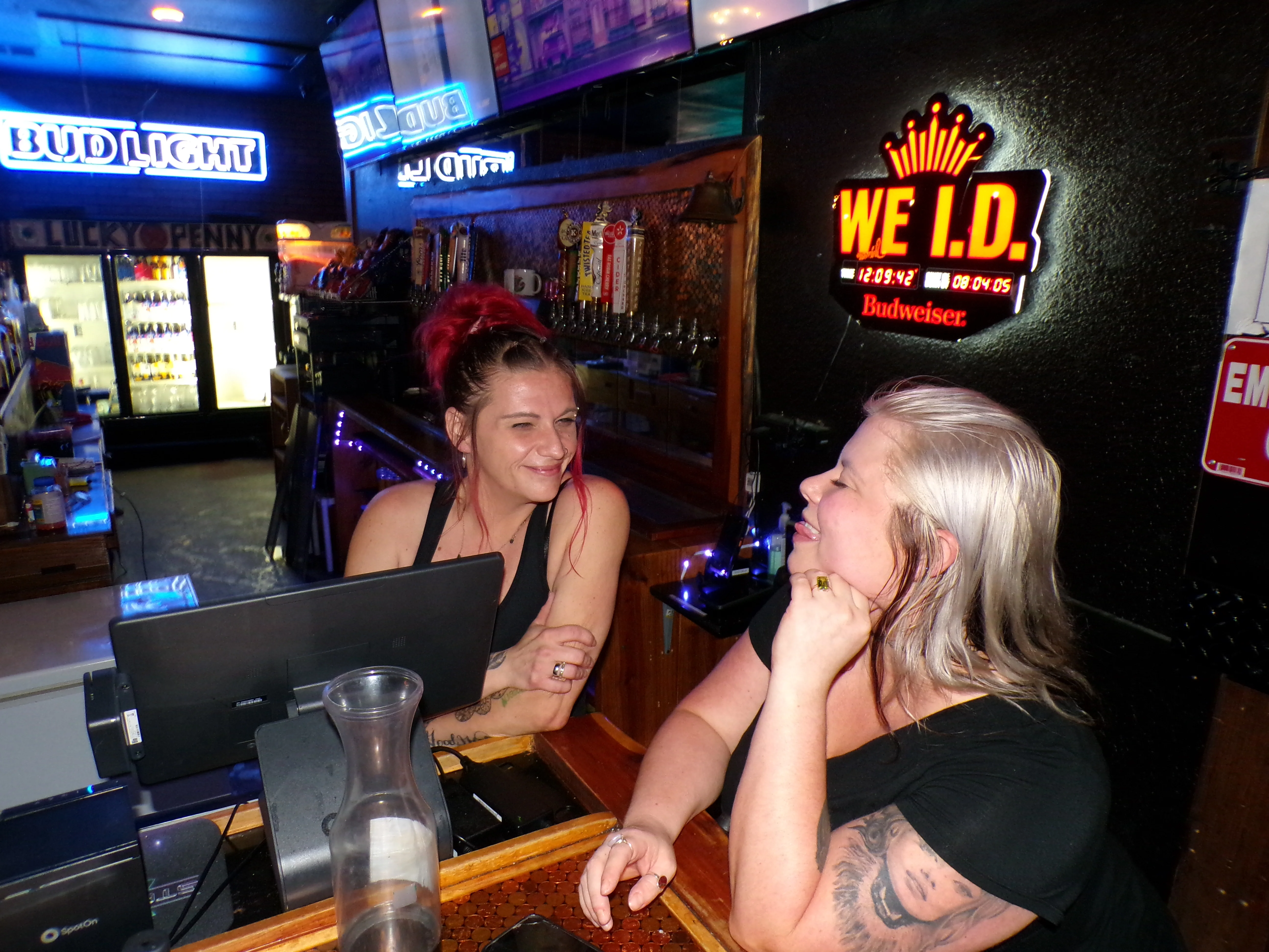 Bartenders enjoying a moment at a lively bar counter